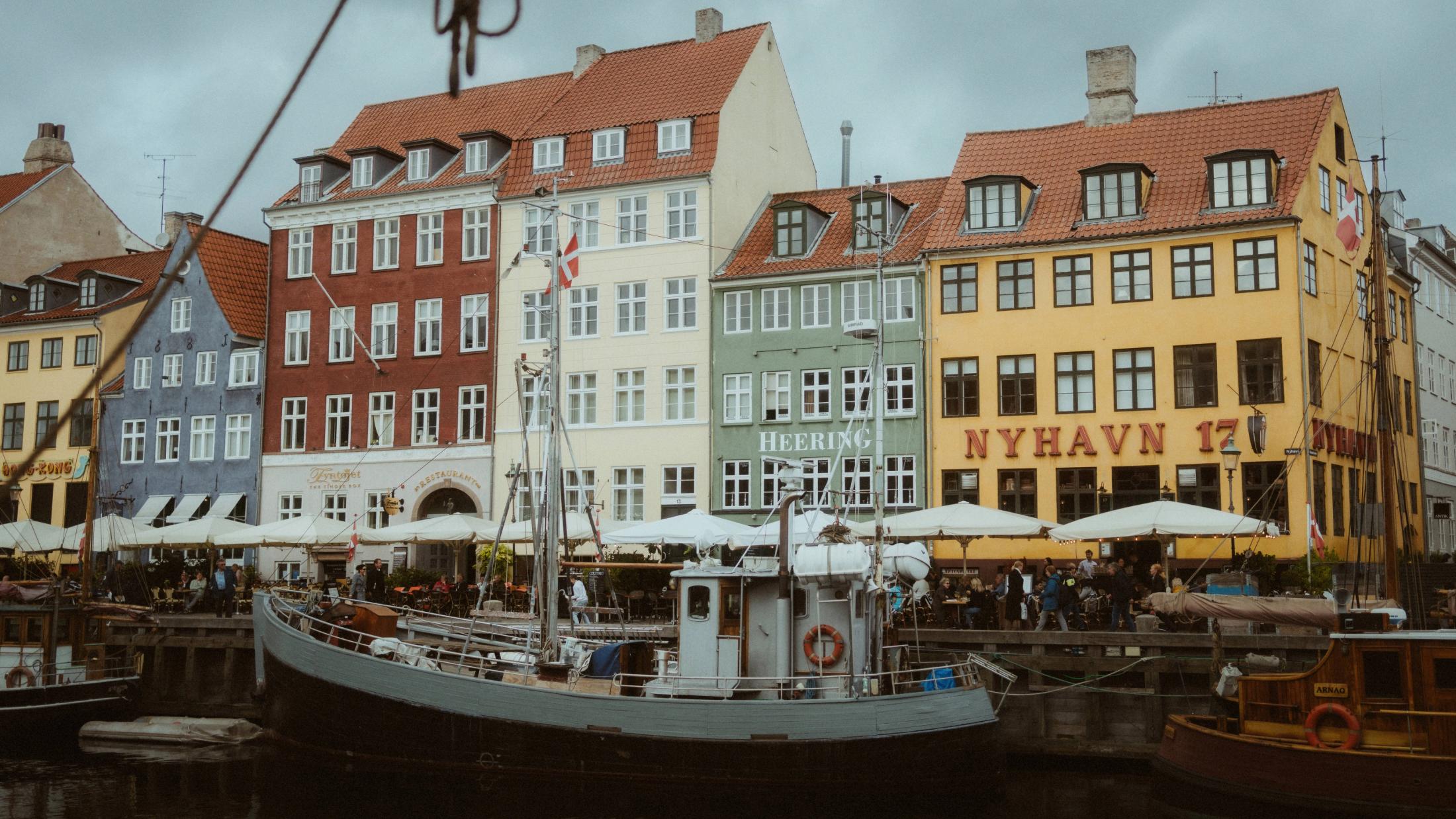 Boats and colorful facades line Copenhagen's Nyhavn waterfront.