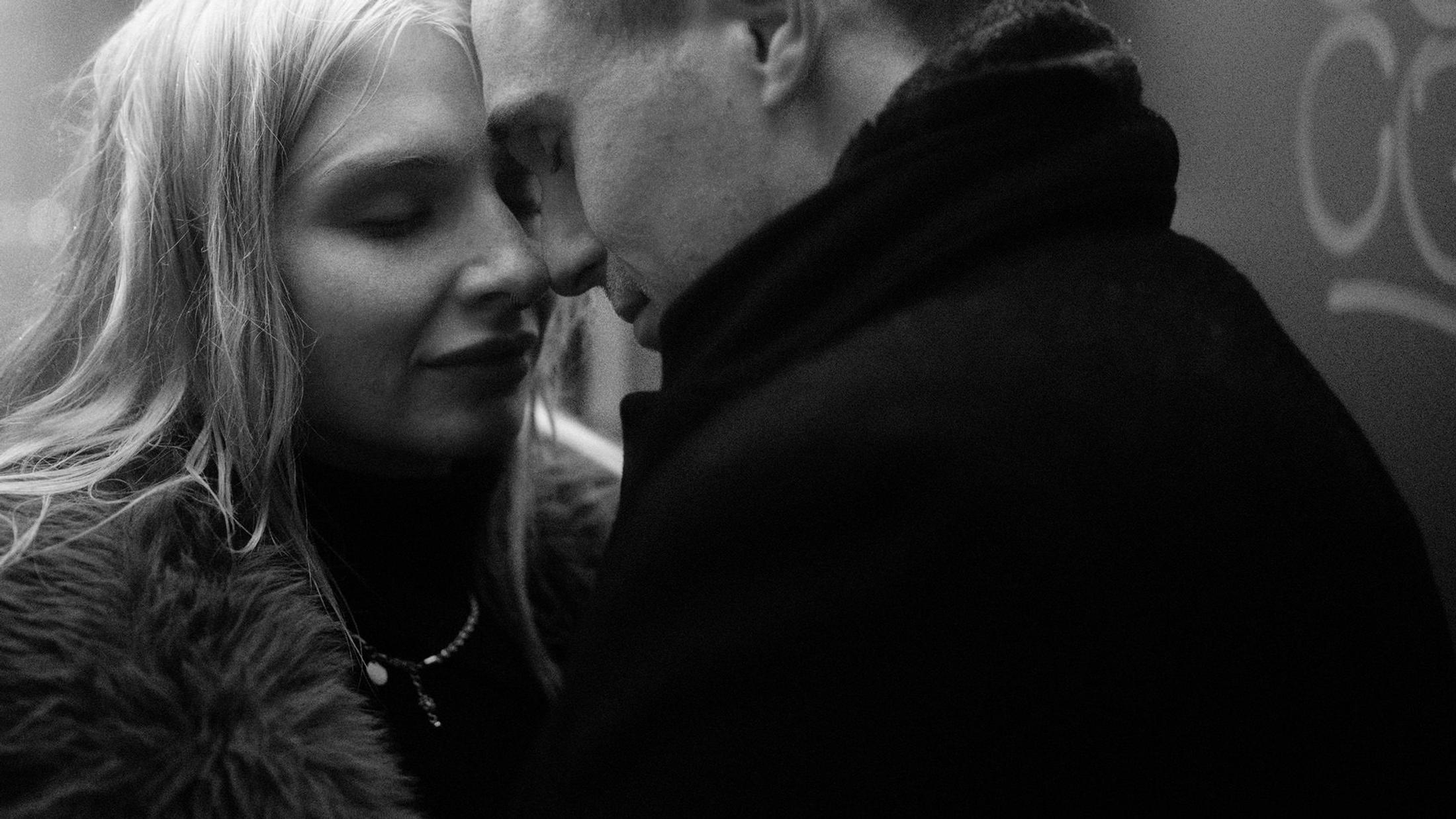 Lorelai smiles close to Steffen as snow settles on their coats.