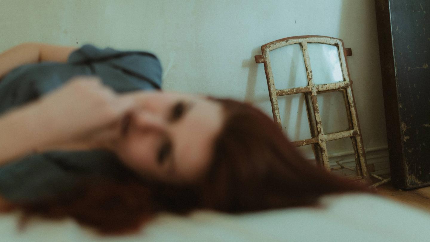 Softly blurred portrait beside a weathered window frame