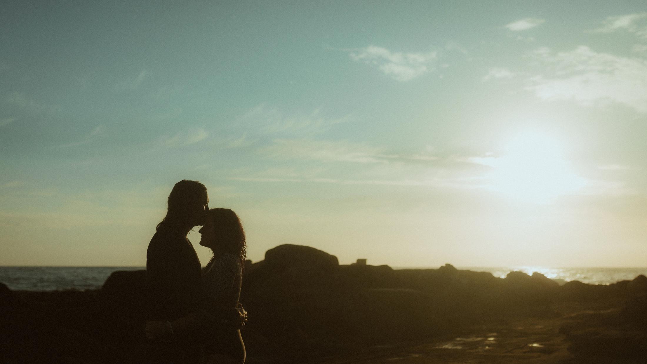 Petra and Roman silhouetted together against the rising sun