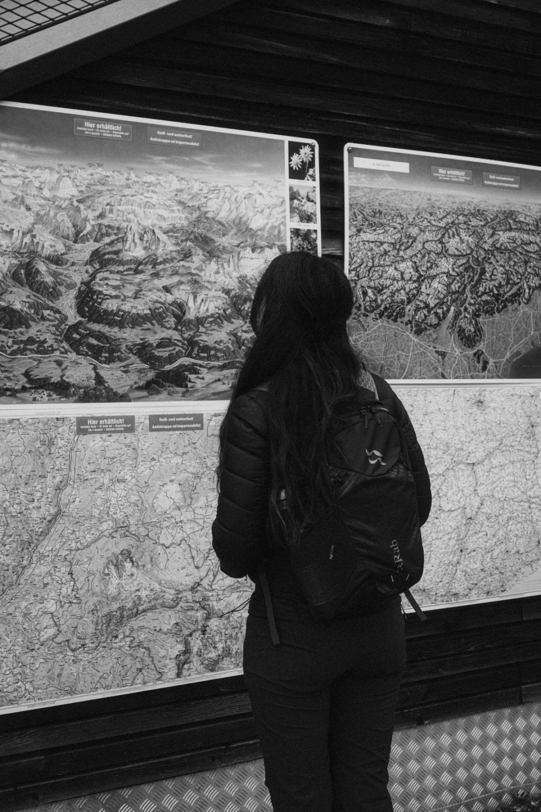 Close view of a trail map held upright outdoors.