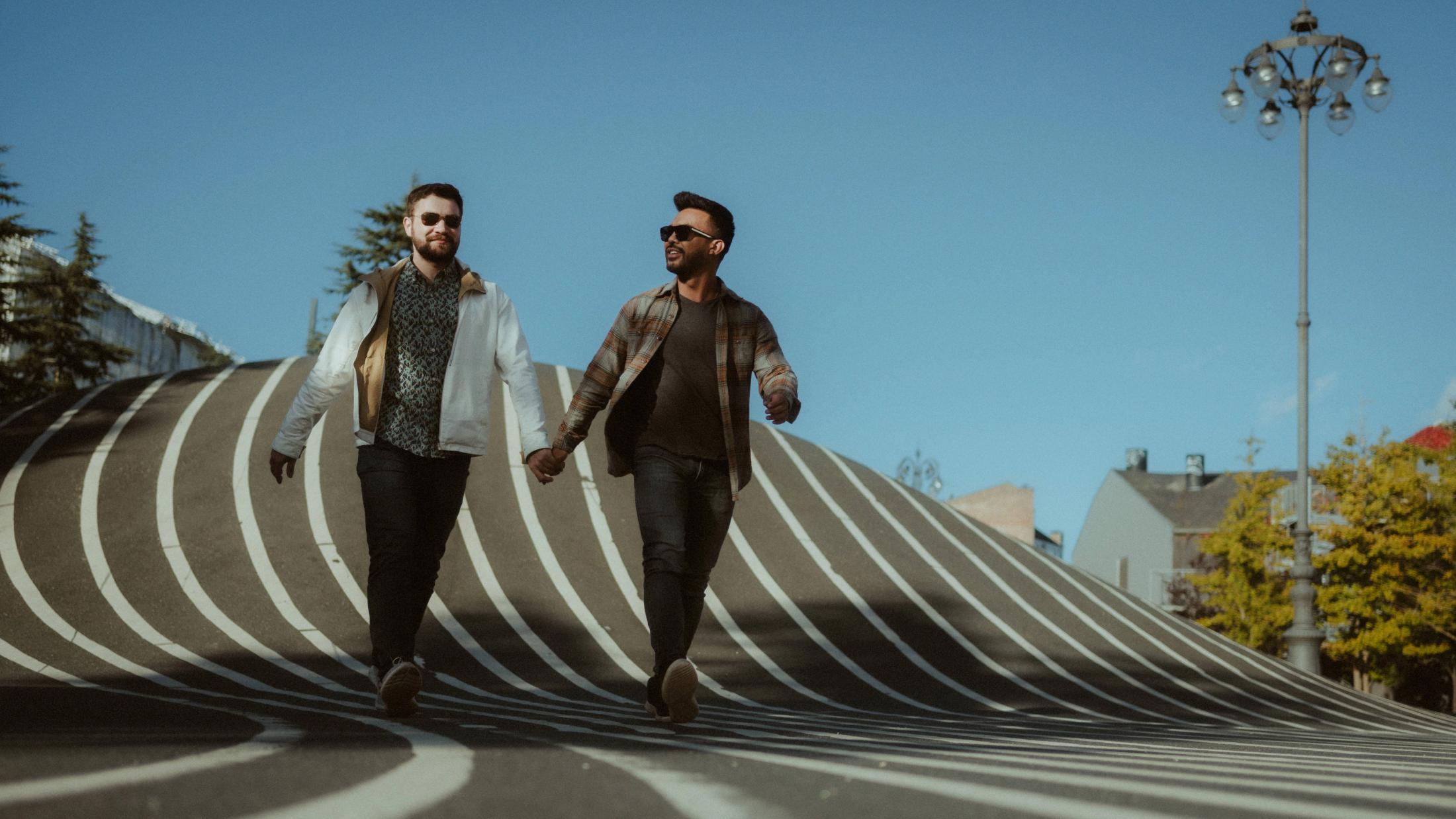 Kris and Ilya walk hand in hand across the black-and-white lines of Superkilen.