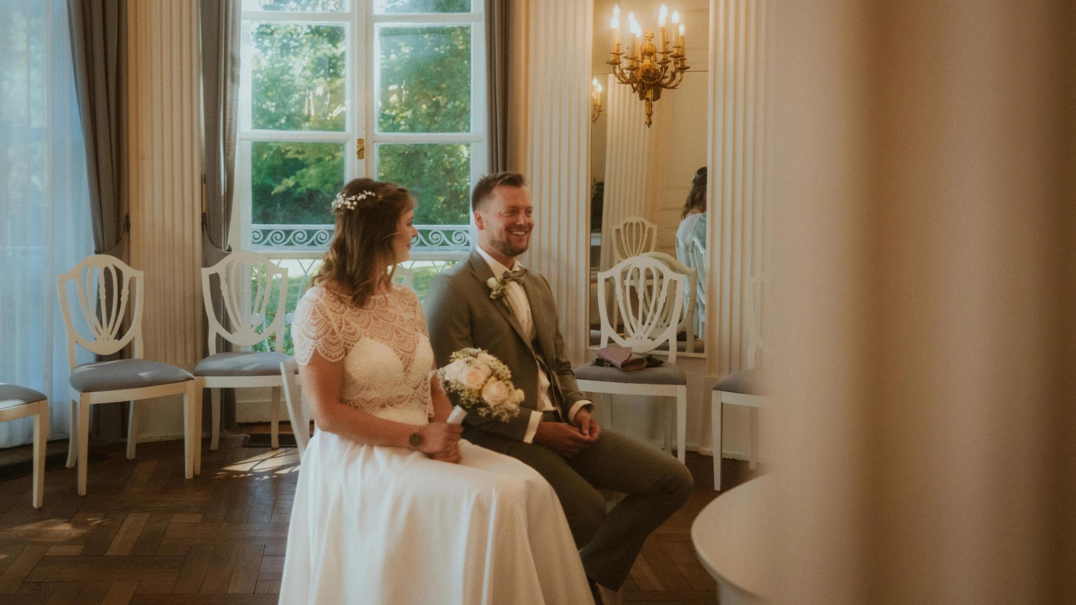 Kira and Jannick seated together during their legal wedding ceremony