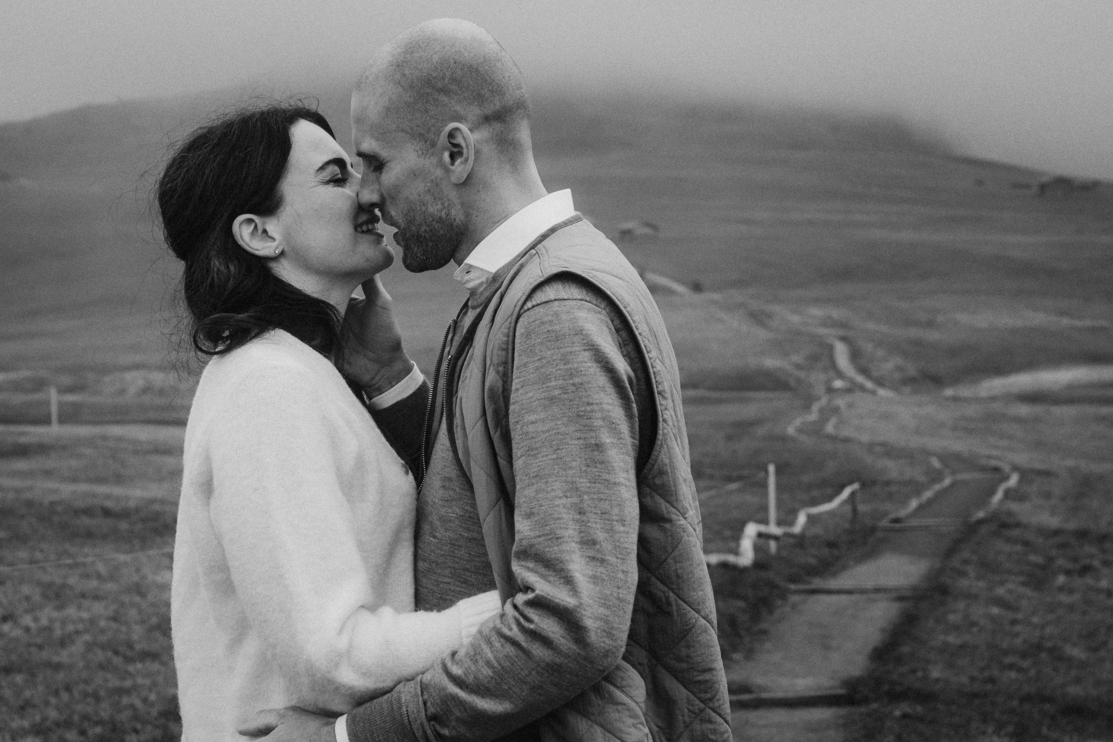 Close black-and-white portrait of Jana and Steffen on the mountain.