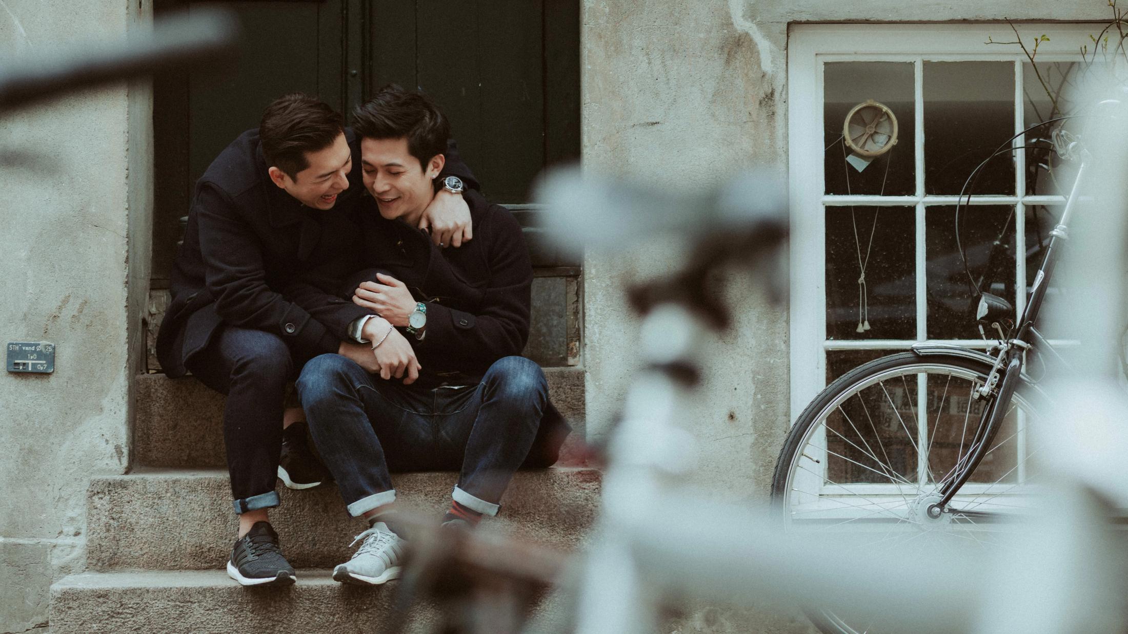 Kevin and Terence share a quiet moment while sitting outside a Copenhagen building.