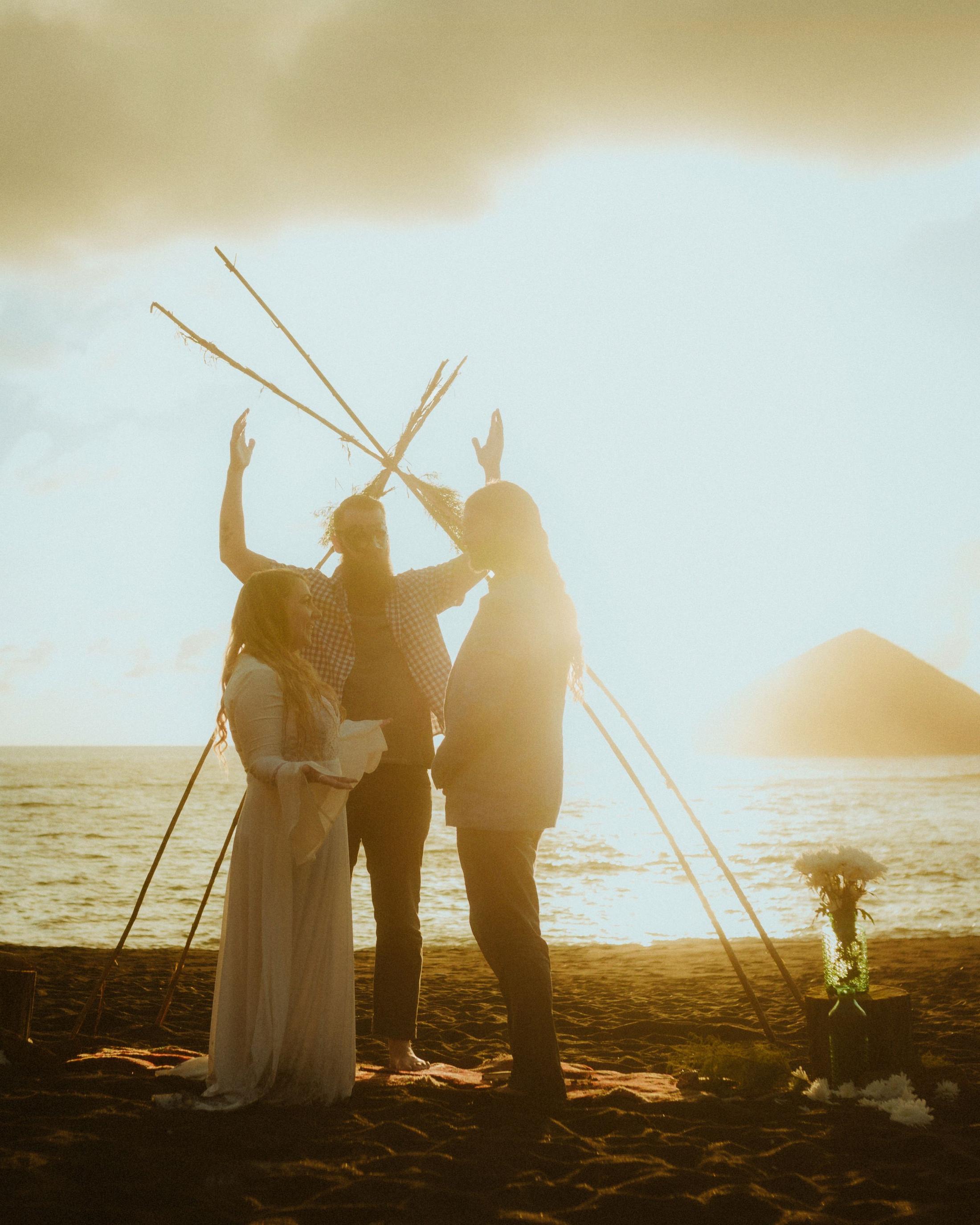 The officiant raises both arms as Twyla and Gary stand together.