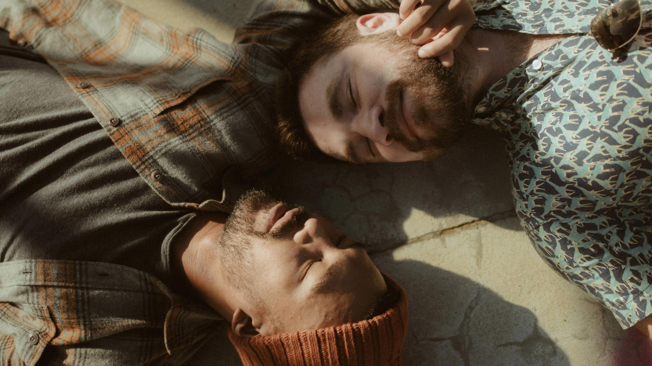 Close overhead portrait of Kris and Ilya lying with their heads beside each other.
