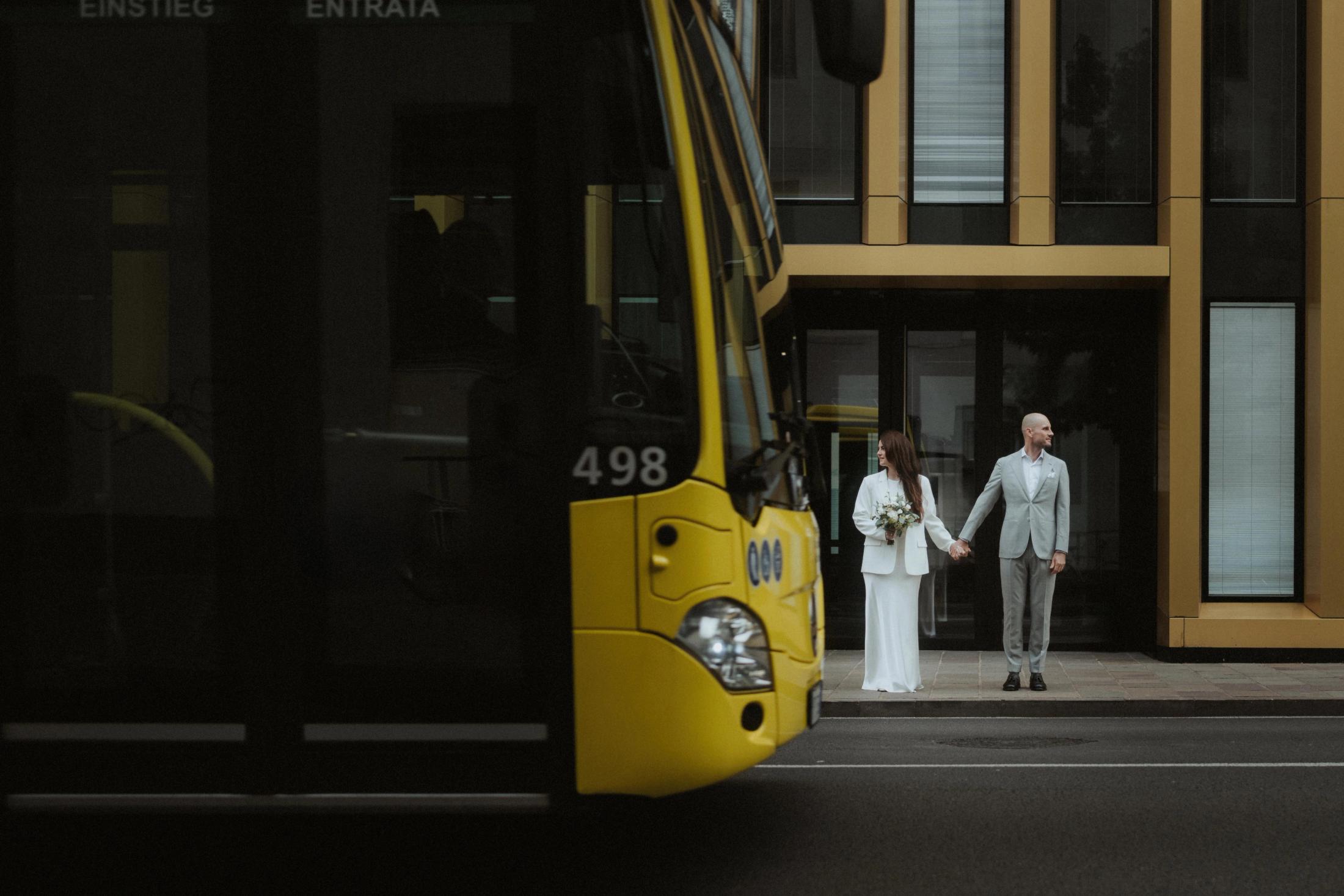 A city bus passing close to Jana and Steffen on a street in Bolzano.
