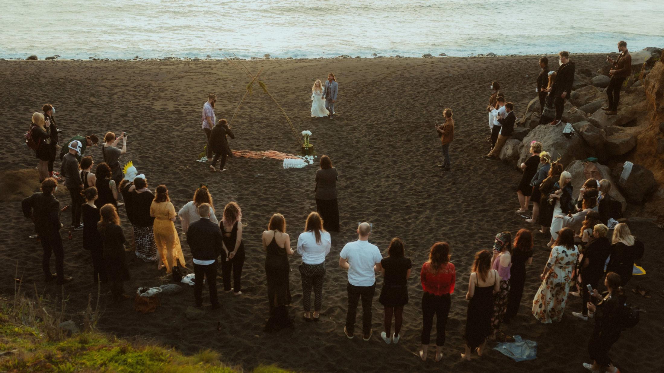 Twyla and Gary stand at their ceremony while the surprised group gathers around them.