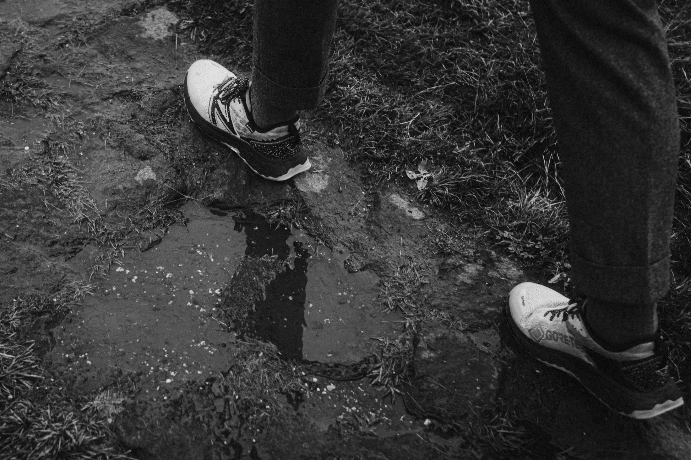 Close view of muddy hiking shoes on the trail.