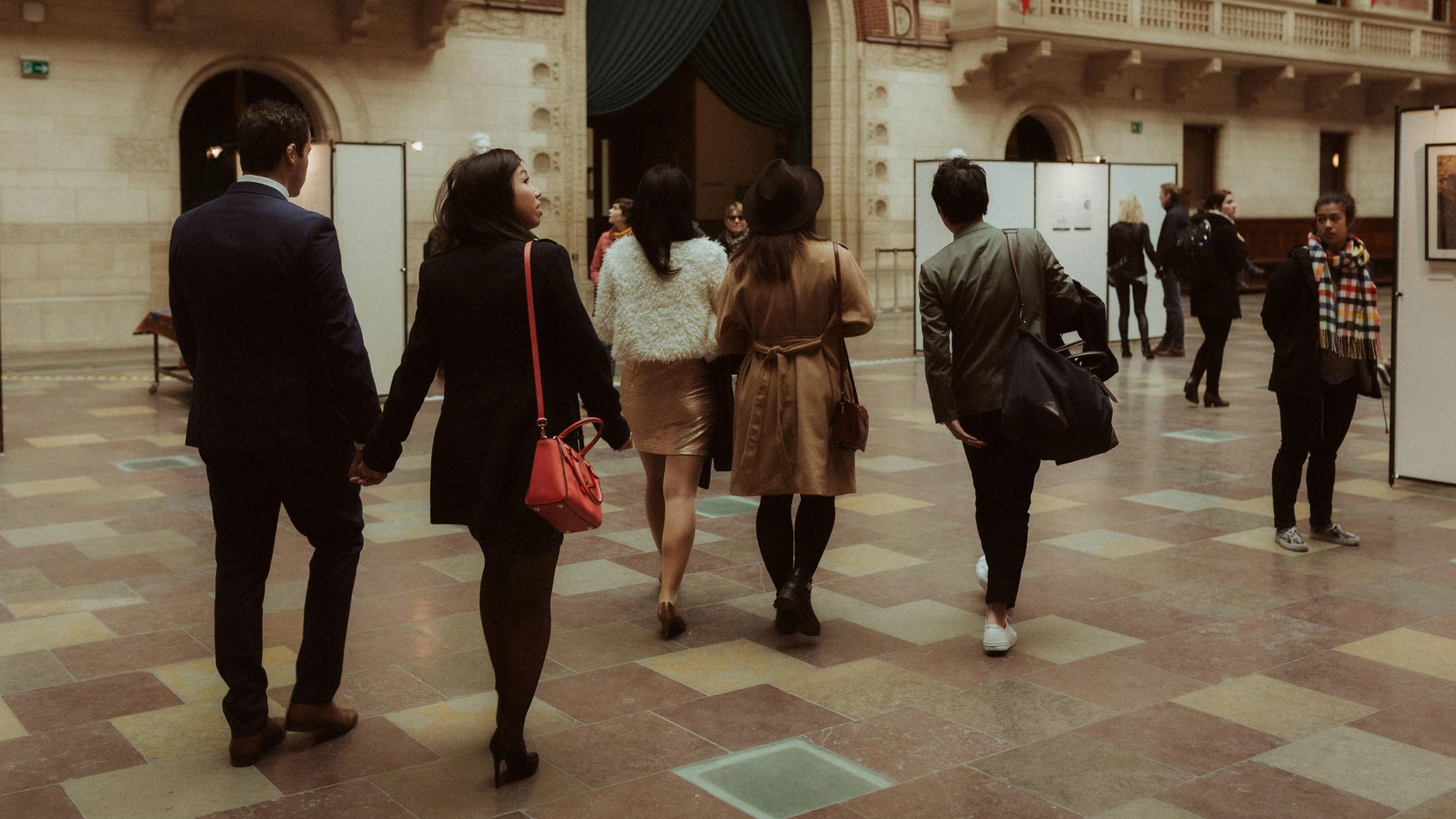 Kevin, Terence and their friends walk away together through Copenhagen City Hall.