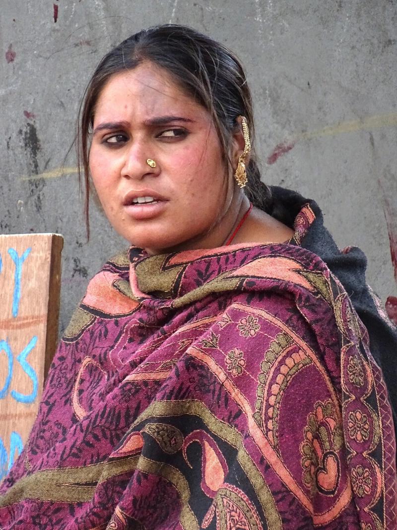 A Himachali woman wearing a magenta-and-olive wool shawl in McLeod Ganj