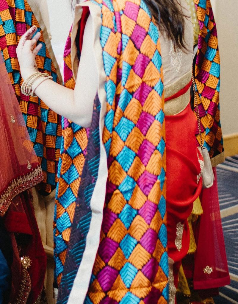 Bridesmaids wearing brightly embroidered Phulkari dupattas at a Punjabi wedding
