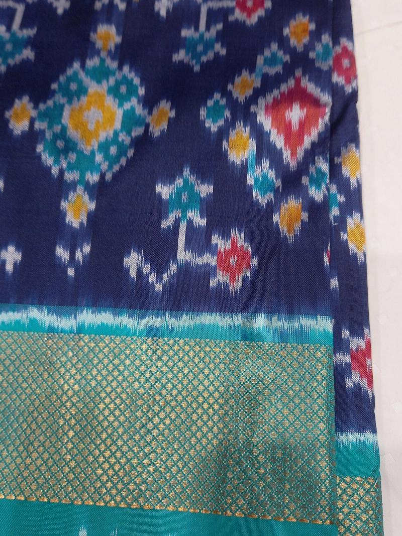 A navy-blue Pochampally ikat saree with diamond-grid motifs