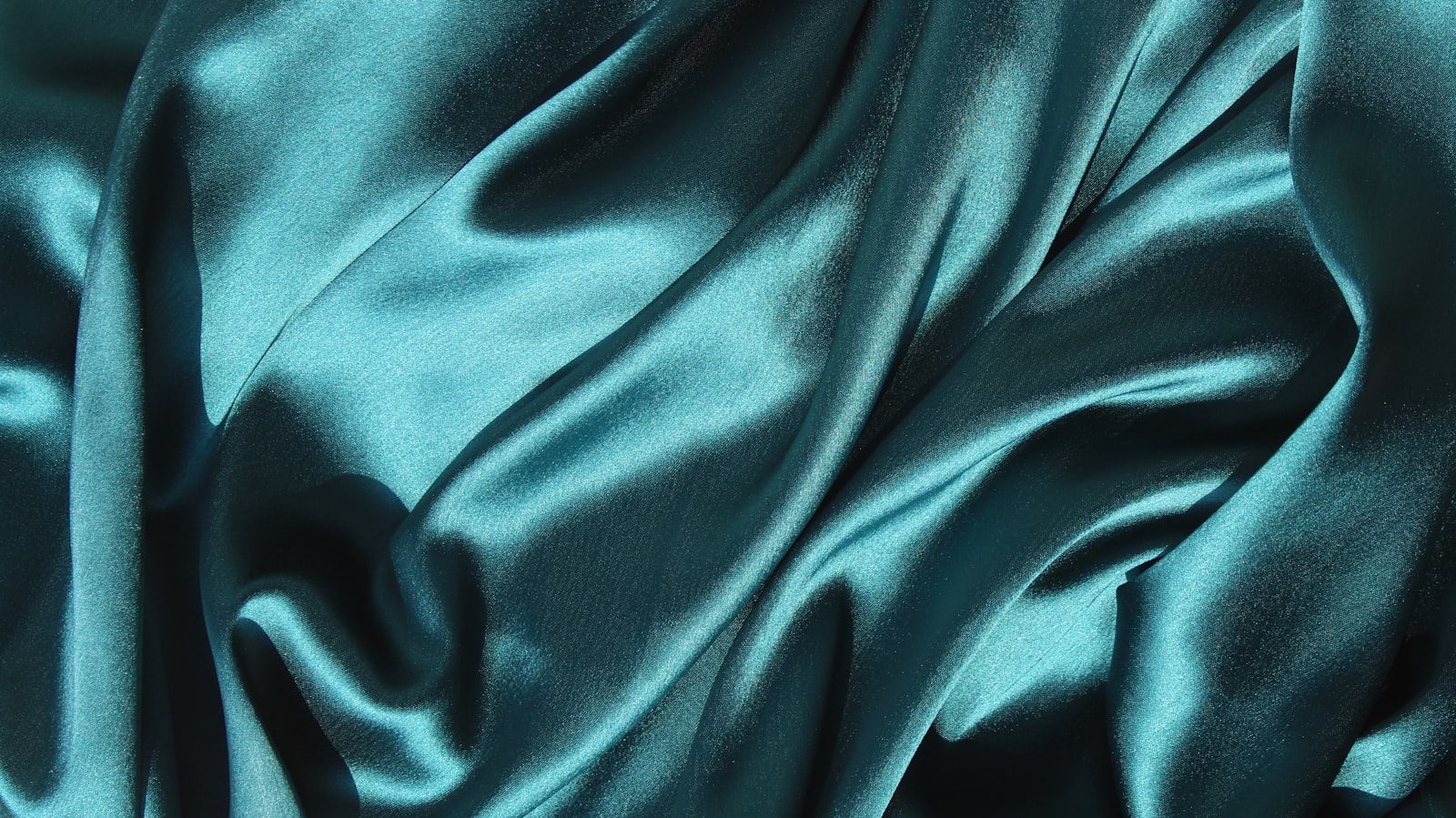 Close-up of a teal Chanderi textile showing the weave
