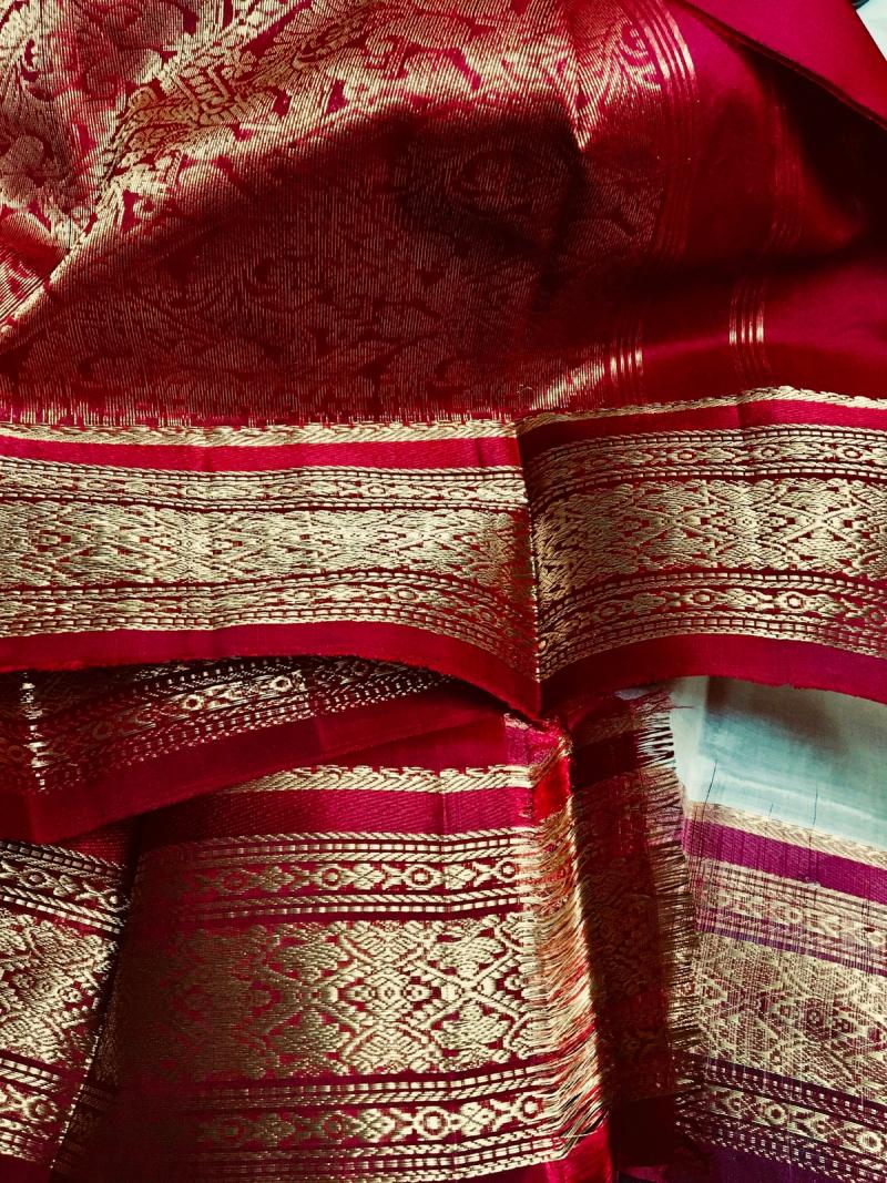 A close-up of red, white, and blue handwoven textile detail