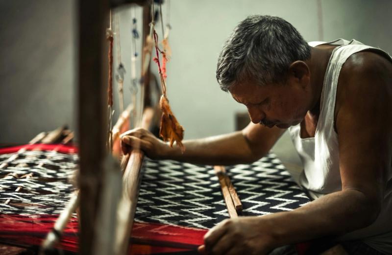 A weaver operating a traditional handloom