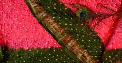 A pink-and-green Gujarat Bandhej (Bandhani) saree showing the classic dot-resist pattern