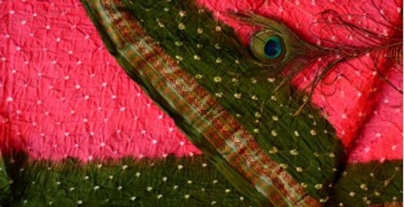 A pink-and-green Gujarat Bandhej (Bandhani) saree showing the classic dot-resist pattern
