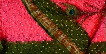 A pink-and-green Gujarat Bandhej (Bandhani) saree showing the classic dot-resist pattern