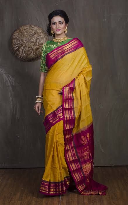 A yellow-cotton Gadwal saree with a magenta silk pallu and gold zari border
