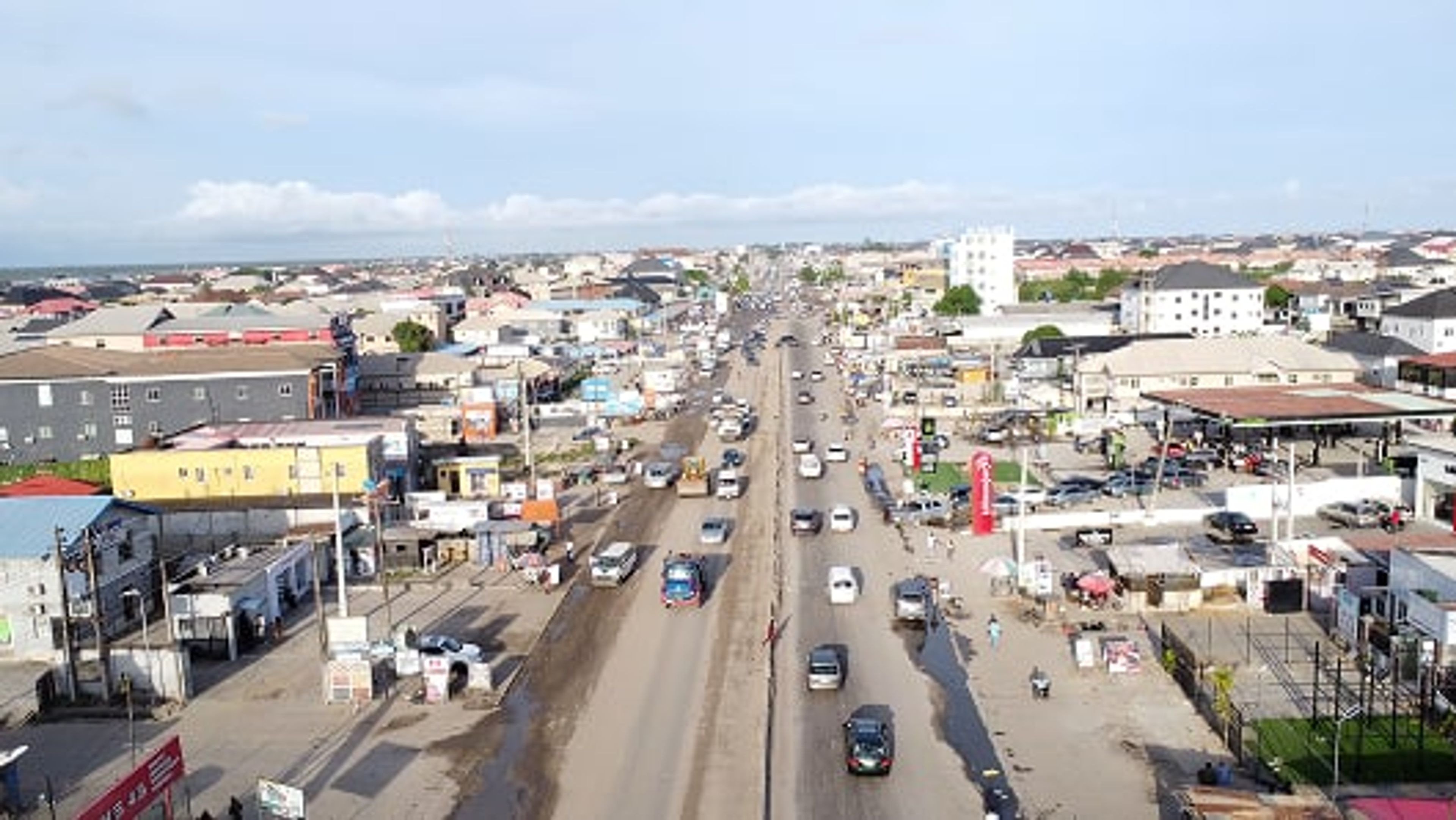 Aerial view of a busy city road lined with buildings