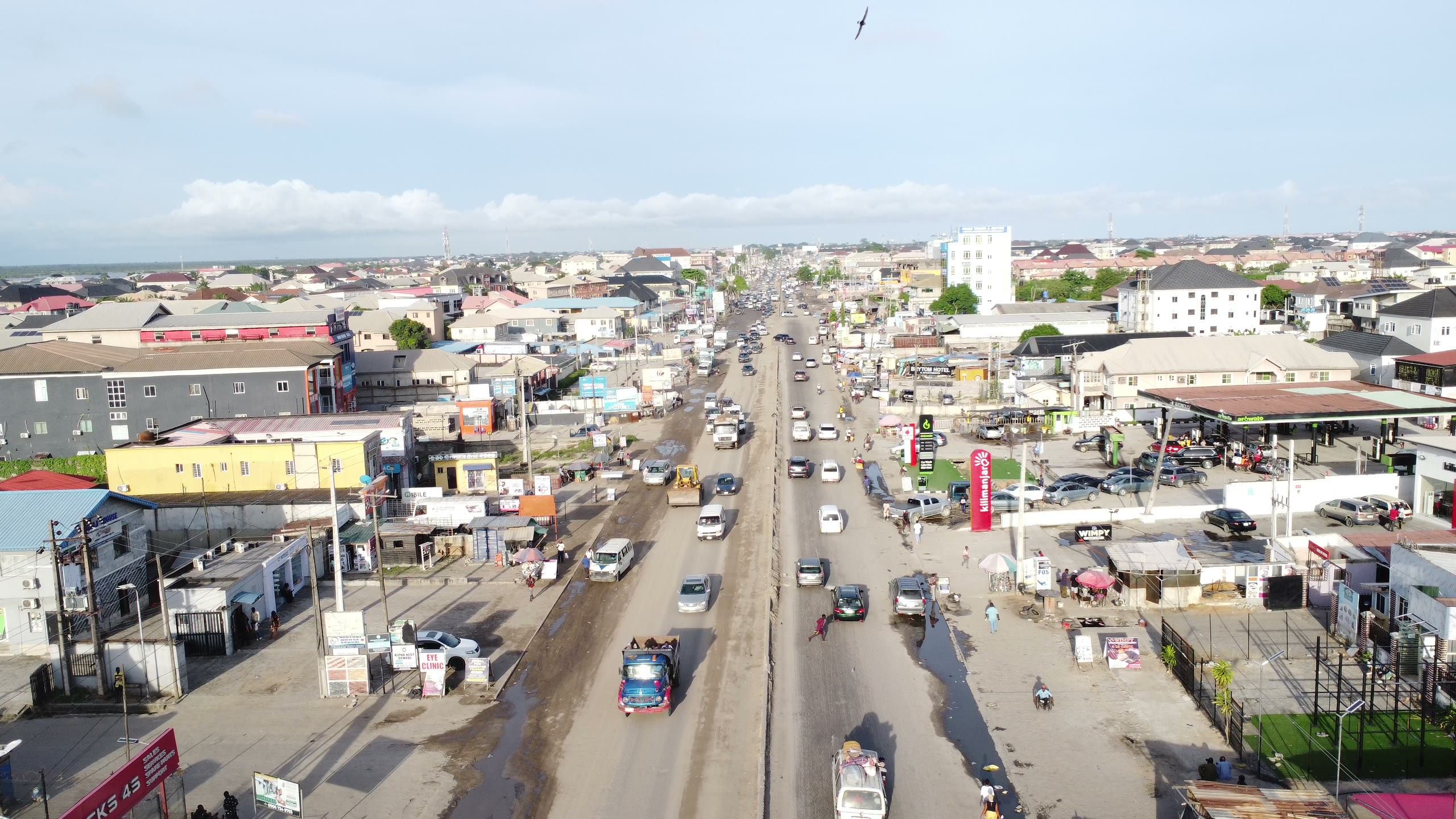 Aerial view of a busy roadside market and traffic on a main road