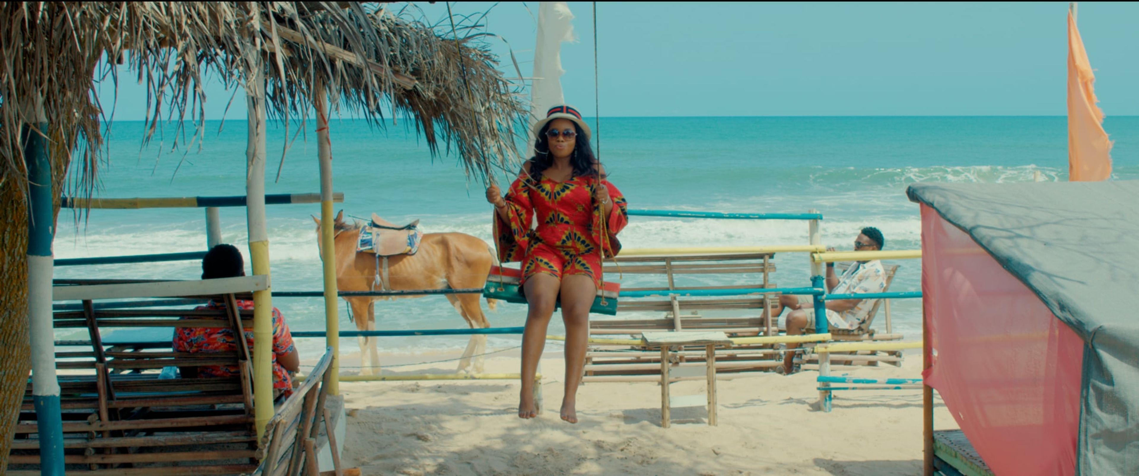 Graded beach scene with a woman on a swing