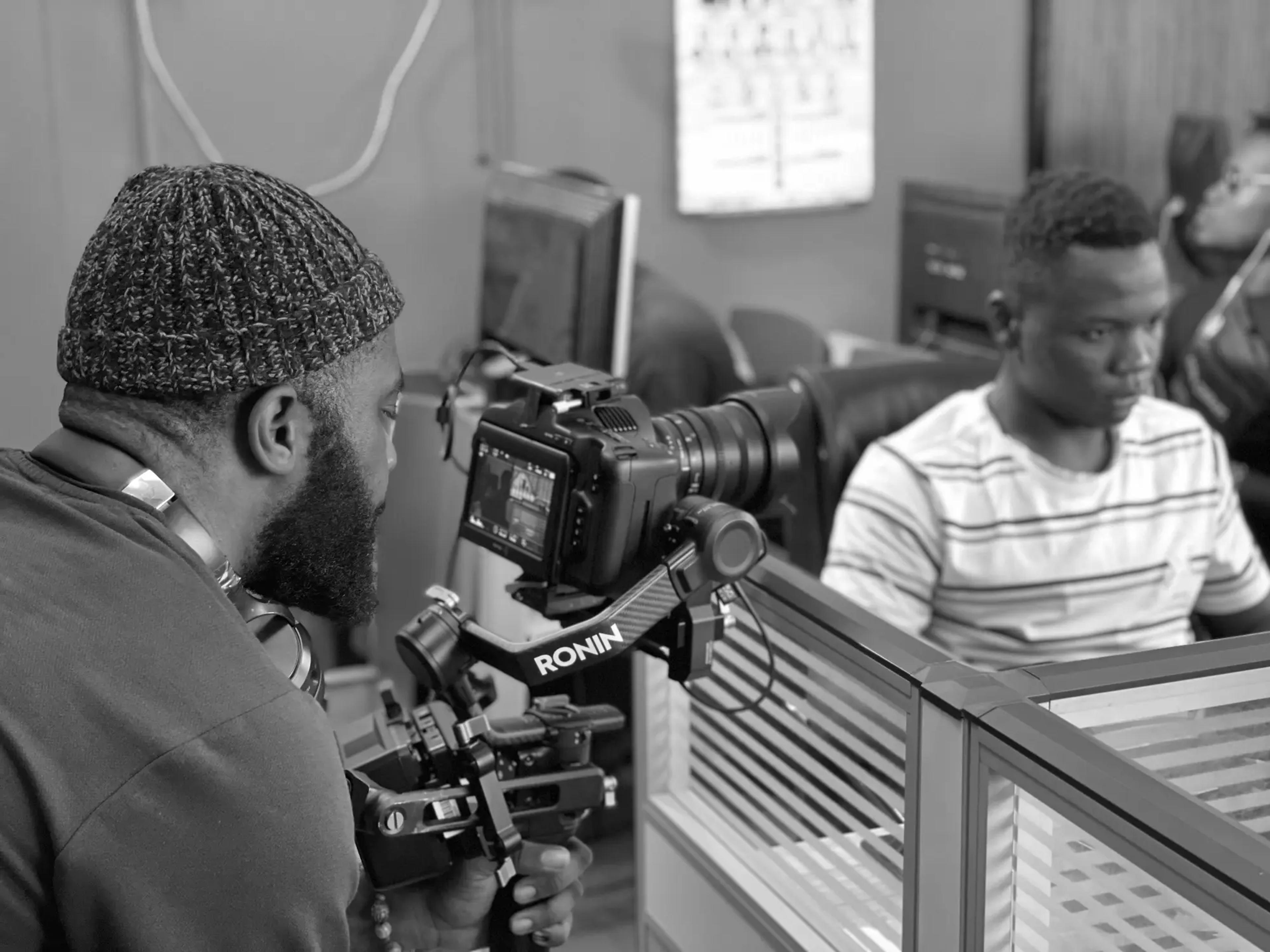 Two of the CUT&JOIN team setting up a camera in the studio