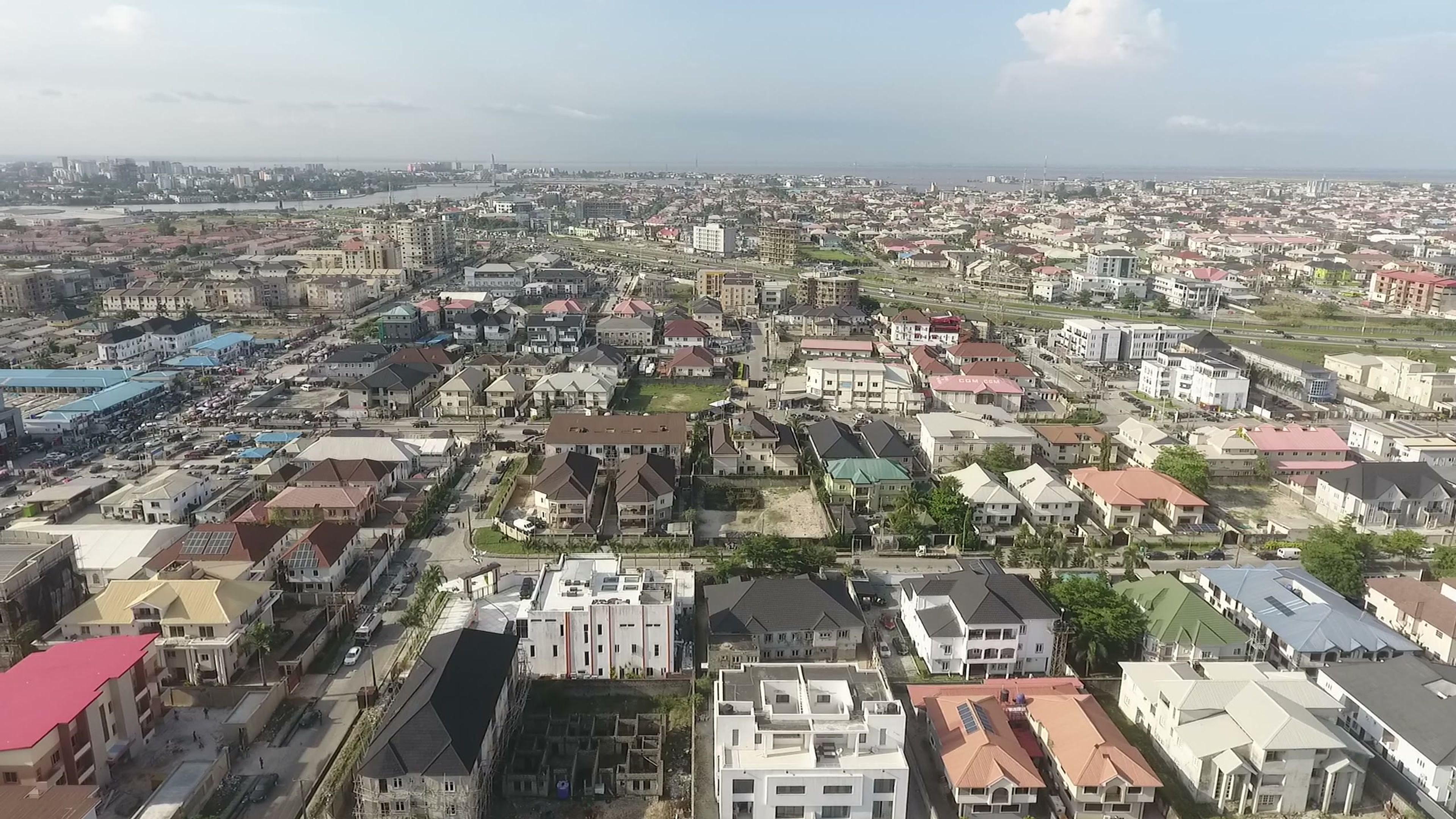 Aerial view of dense residential rooftops stretching to the horizon