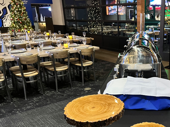 The holiday buffet station with chafing dishes set on wood-slice risers