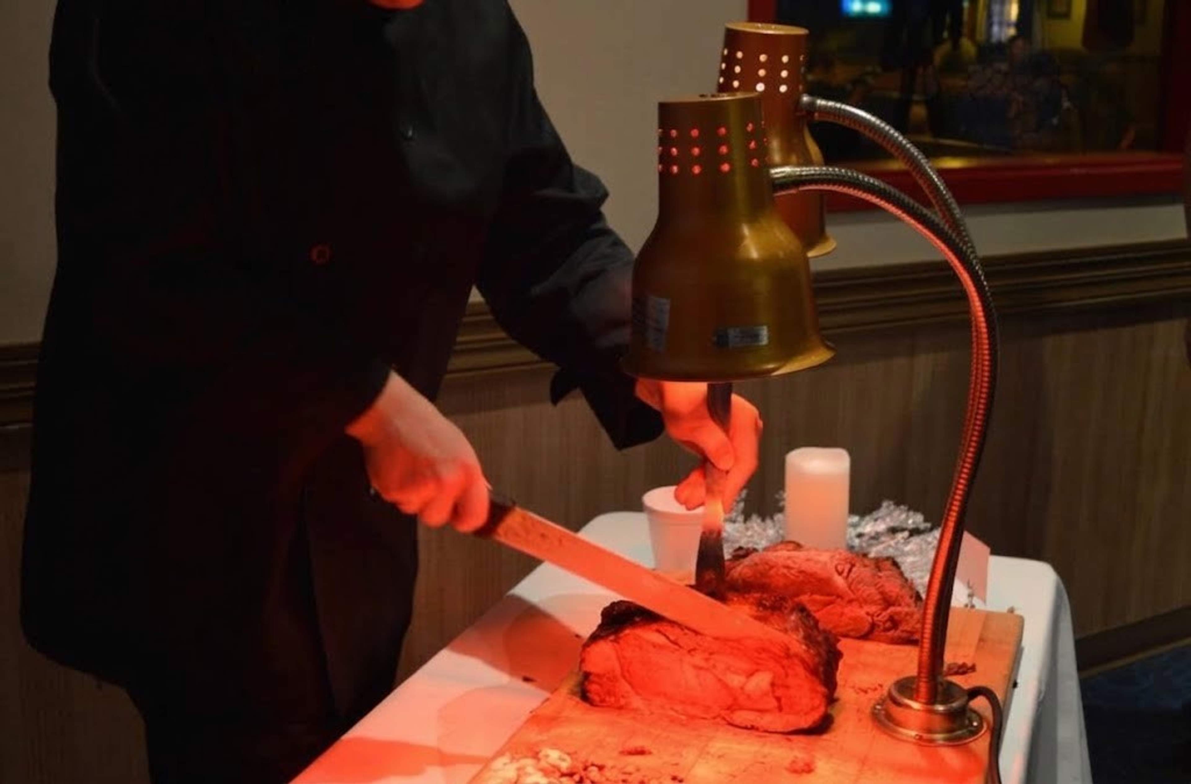 A chef carving roast at the holiday buffet carving station