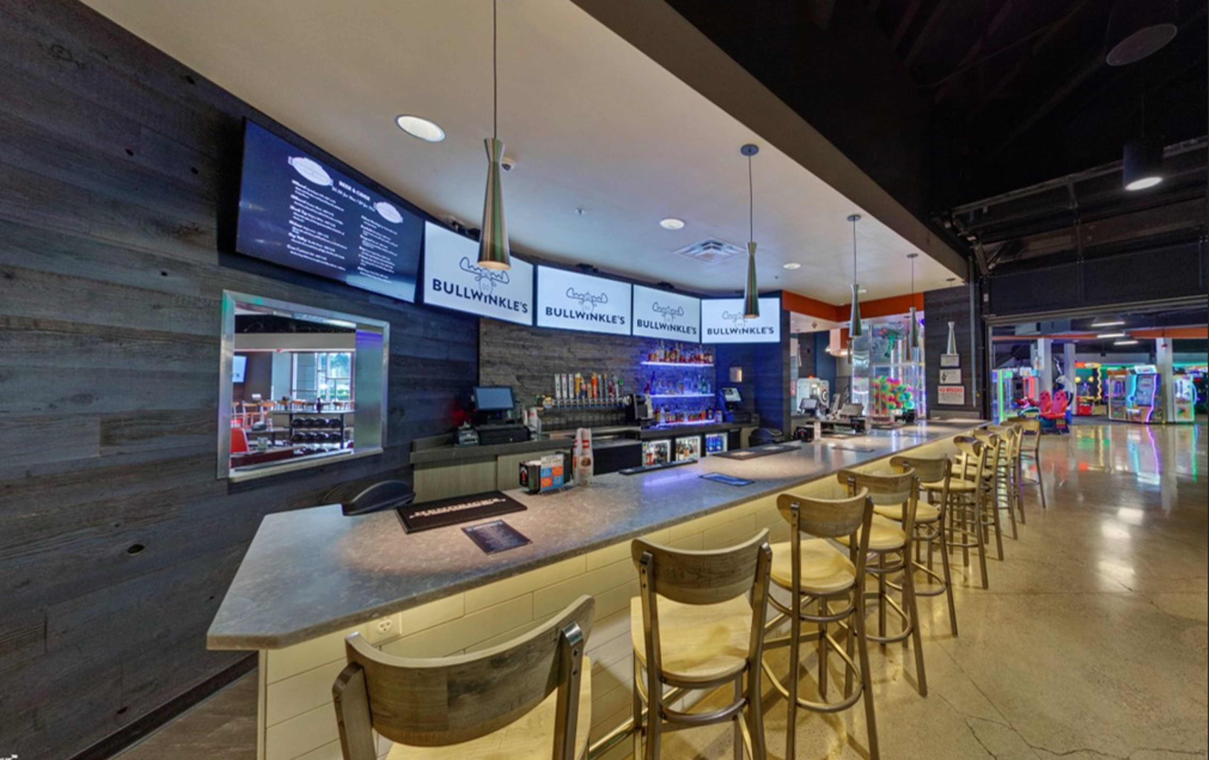 The Badenov's Bar counter with its row of taps, back-bar bottles and Bullwinkle's screens