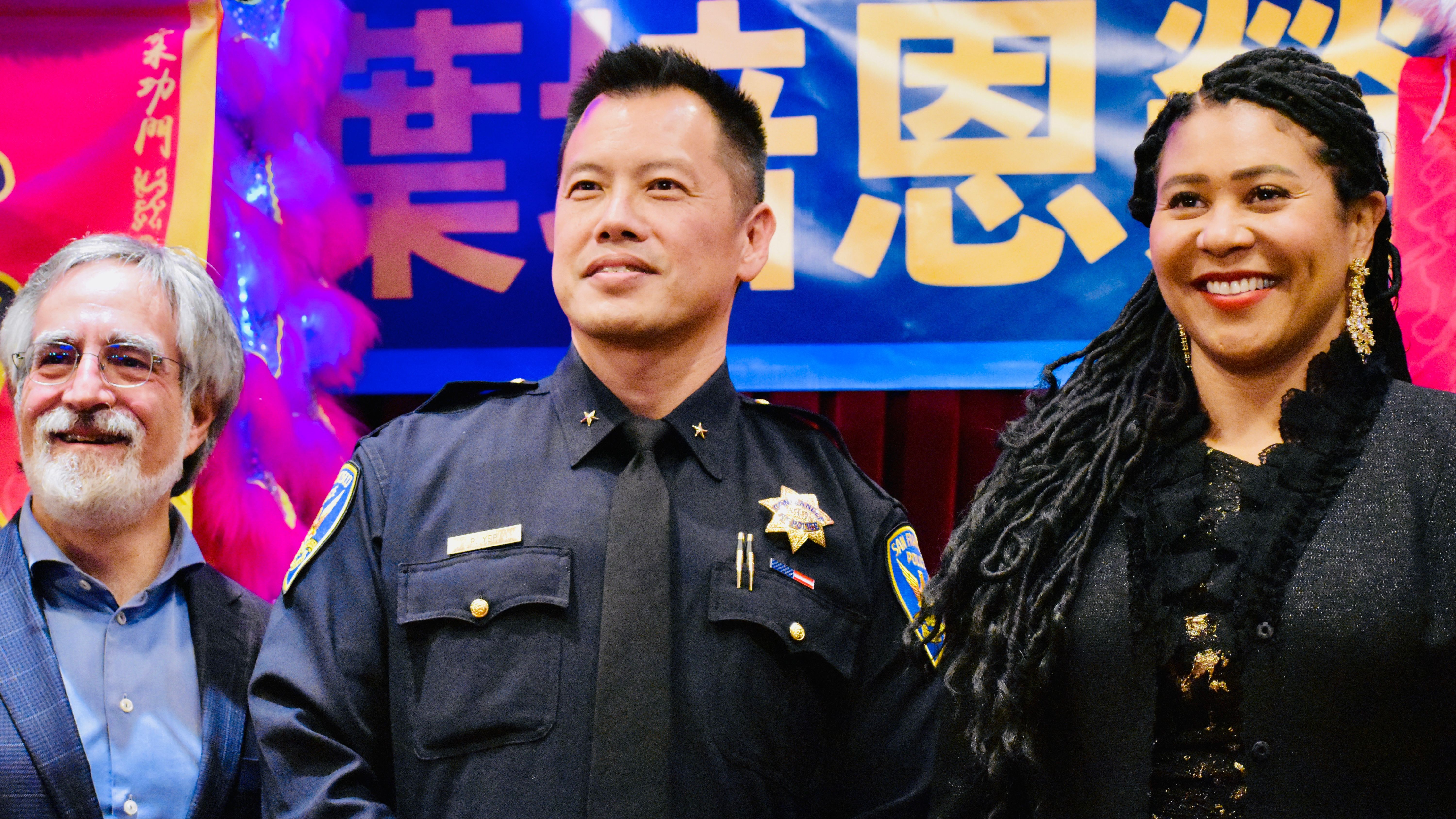 Mayor London Breed (right) and Supervisor Aaron Peskin (left) congratulate new Police Commander Paul Yep (center). Photo by Portia Li