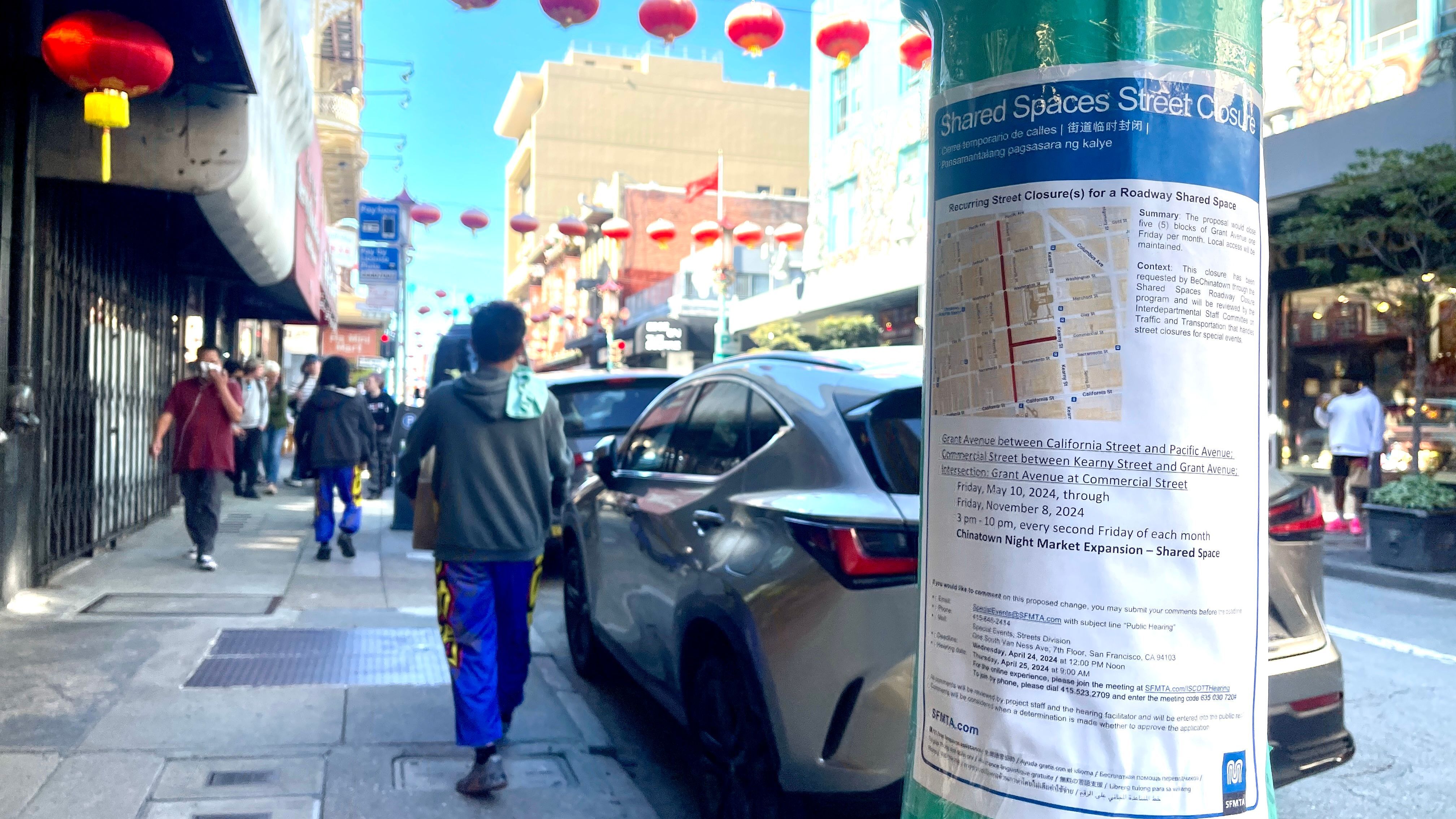 An English-only street closure permit application notice is posted on a light pole on Grant Avenue. It seeks to expand the Chinatown night market venue from 3 to 5 blocks on Grant Avenue. Photo by Portia Li