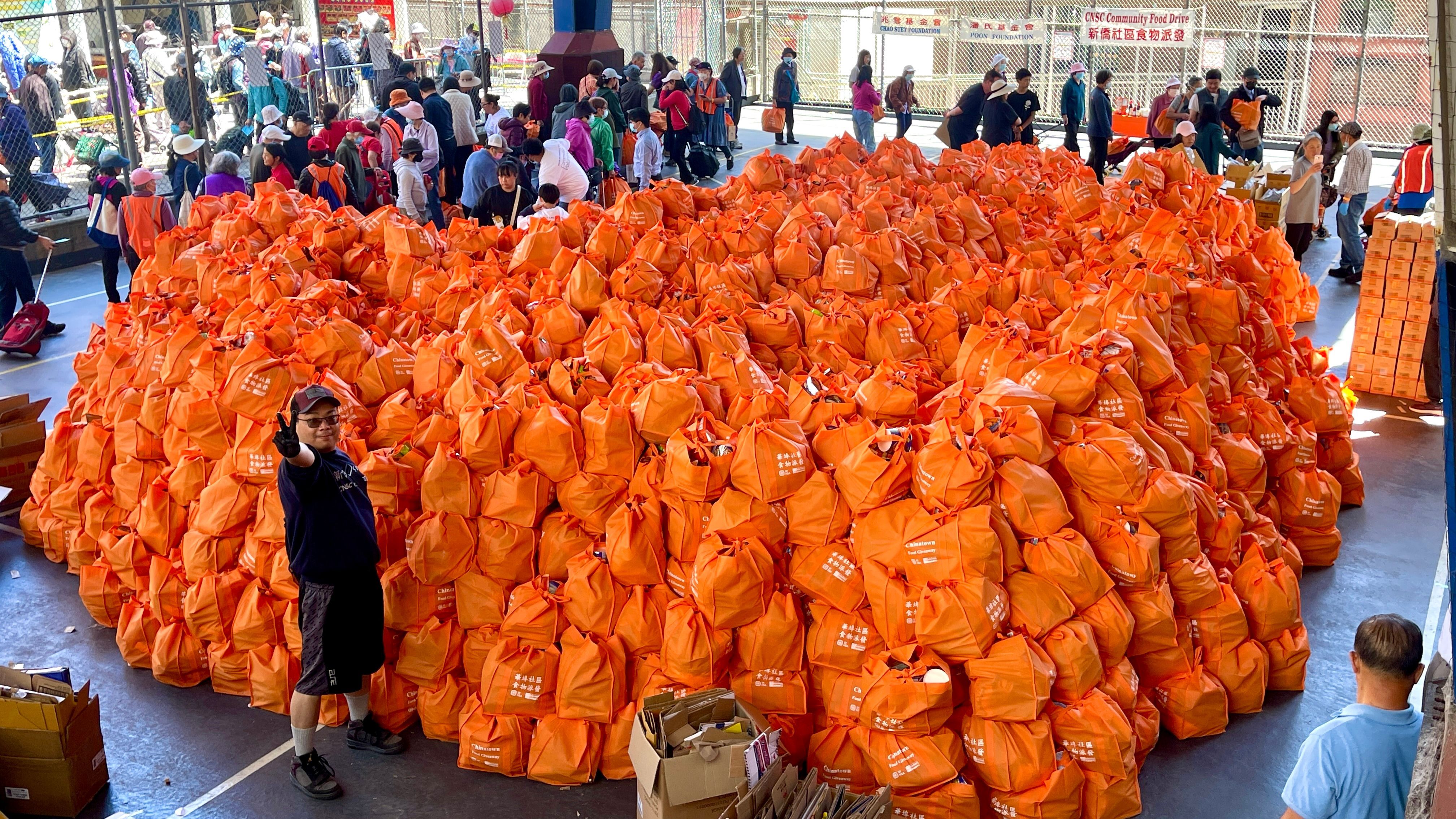 5,000 food bags represent $375,000 in total value. George Chan wants to ensure all the free food are secured for the underserved community and stays overnight watching them. Photo by Portia Li