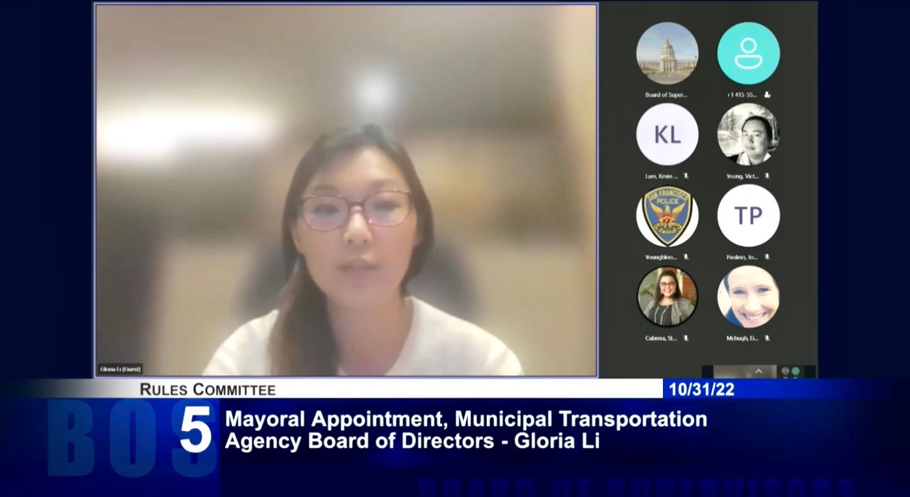 Gloria L,i who is currently in Hong Kong visiting her family, answers questions remotely at the Board of Supervisors’ Rules Committee hearing. Screenshot photo