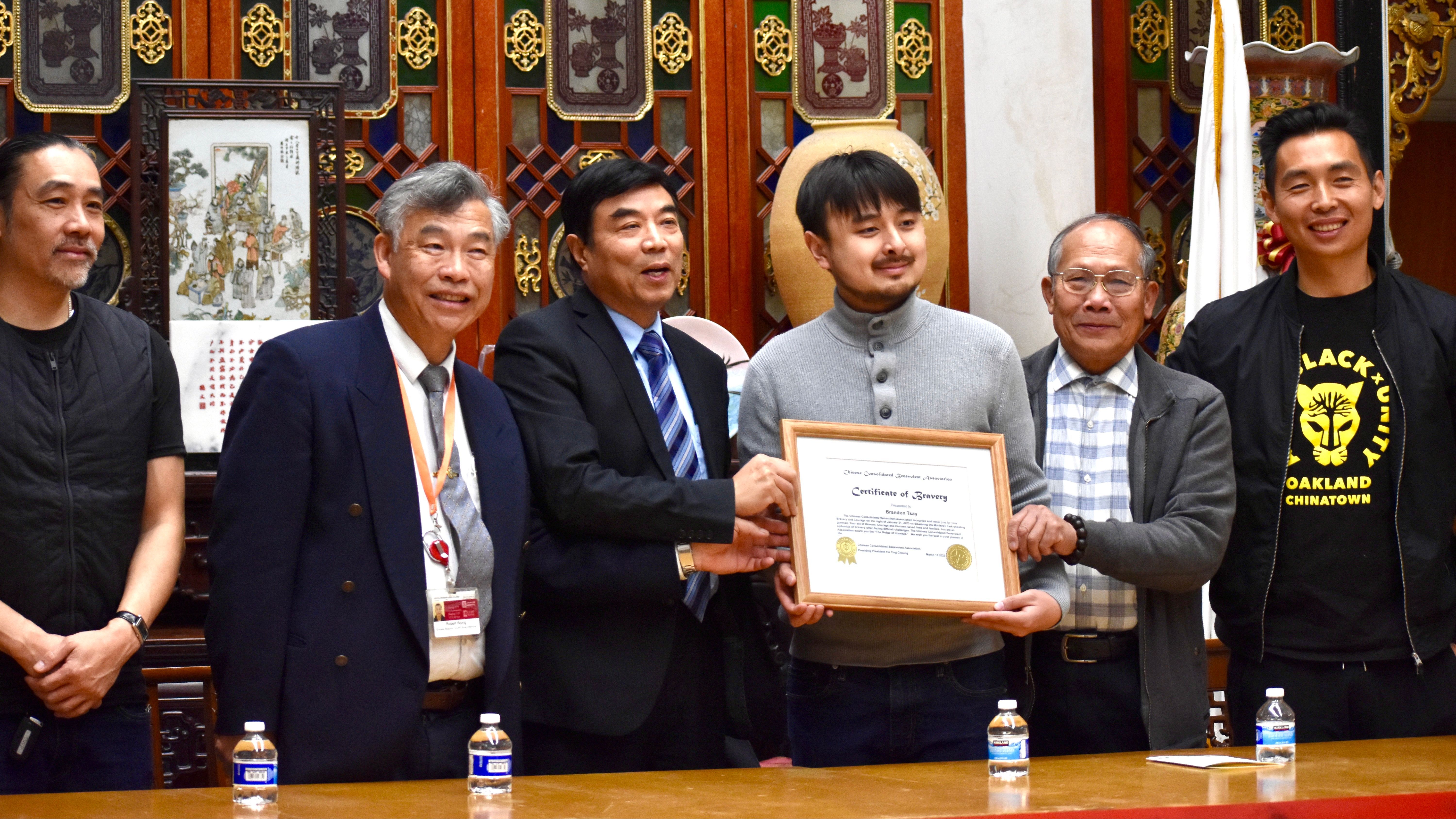 Brandon Tsay (third from right), a hero in the Monterey Park mass shooting, is welcomed by community leaders at the Chinese Consolidated Benevolent Association in Chinatown. Photo by Portia Li