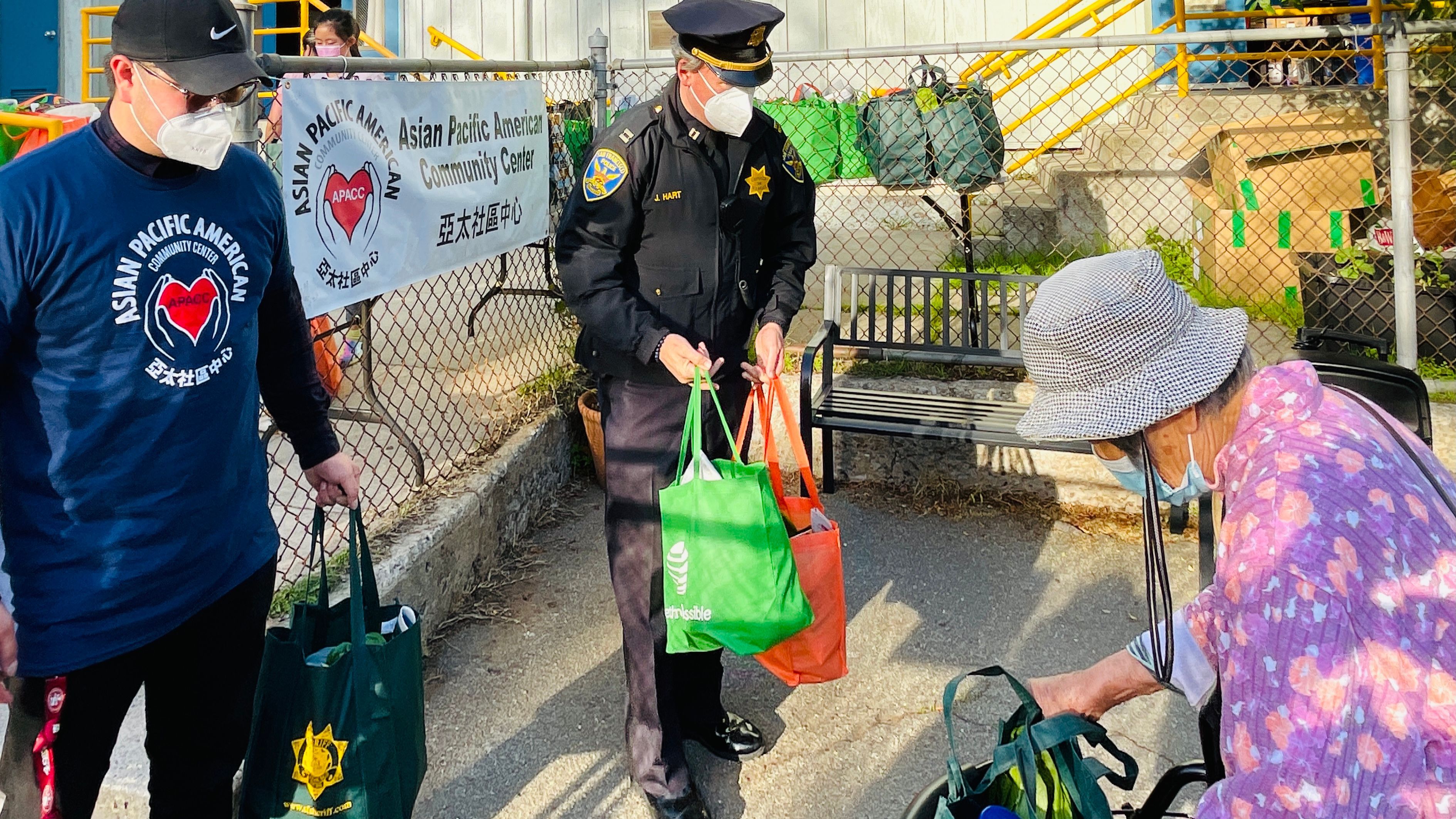 Police Academy Captain Jack Hart (center) delivered the food bags to Visitacion Valley seniors. Photo by Portia Li