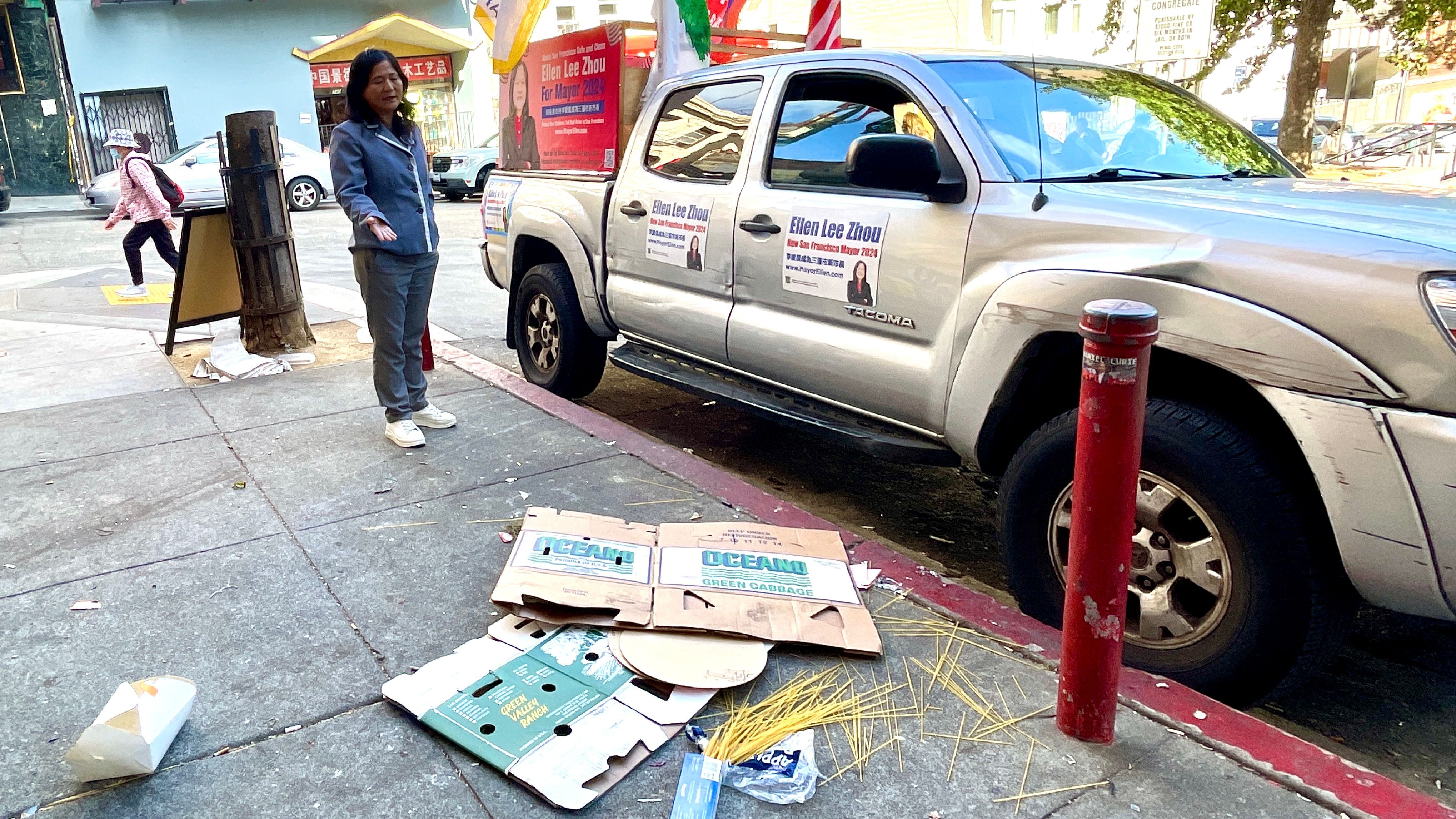 Ellen Lee Zhou stands on Walter Lum Place in Chinatown at noon on October 21, Monday, where garbage could be seen around the entire alley.  Photo by Portia Li