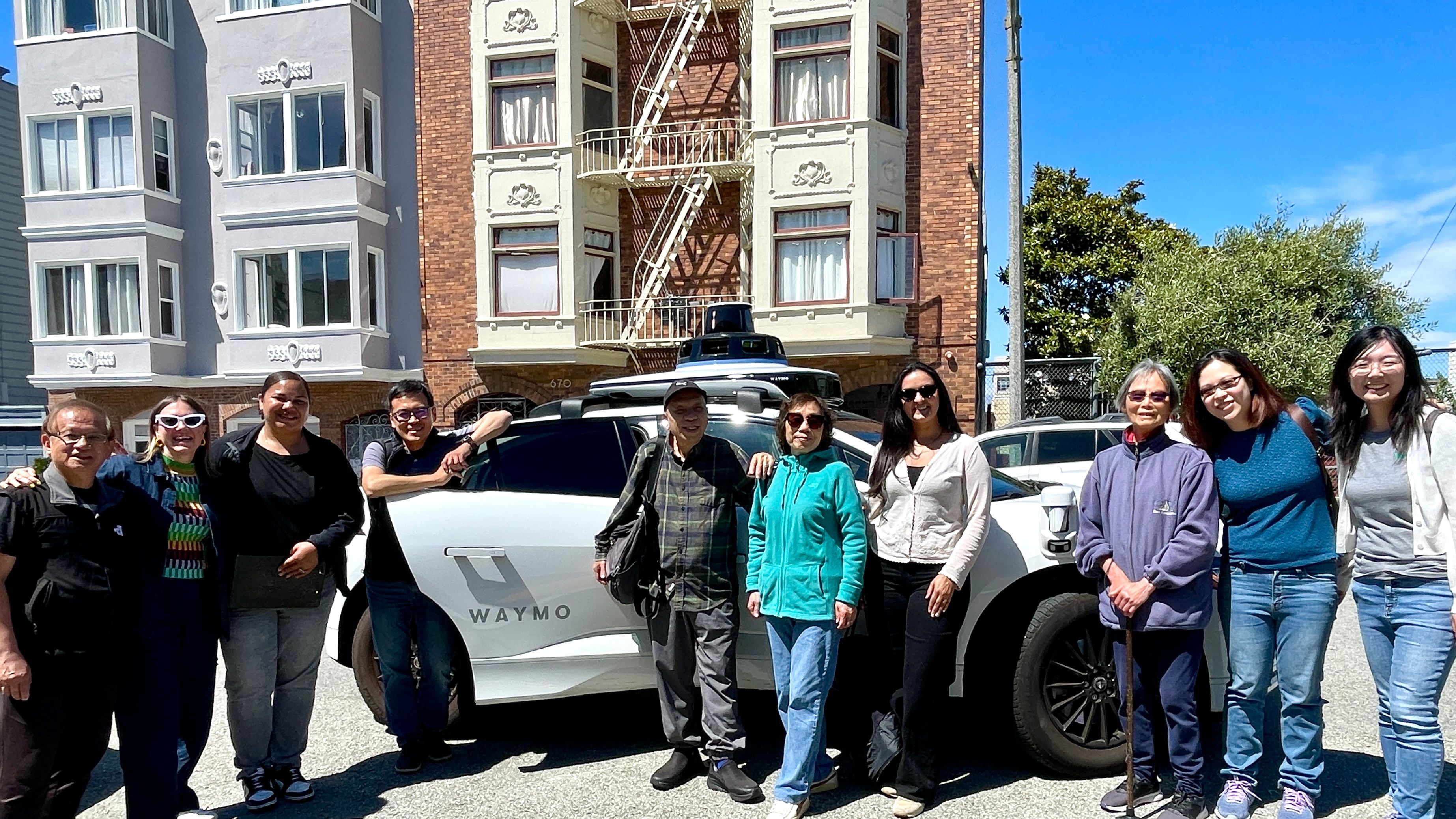 Four Waymo representatives including Chinese-speaking staffers demonstrate Waymo’s autonomous vehicle services to members of the Telegraph Hill Neighborhood Center’s senior program in the North Beach neighborhood of San Francisco. Photo by Portia Li