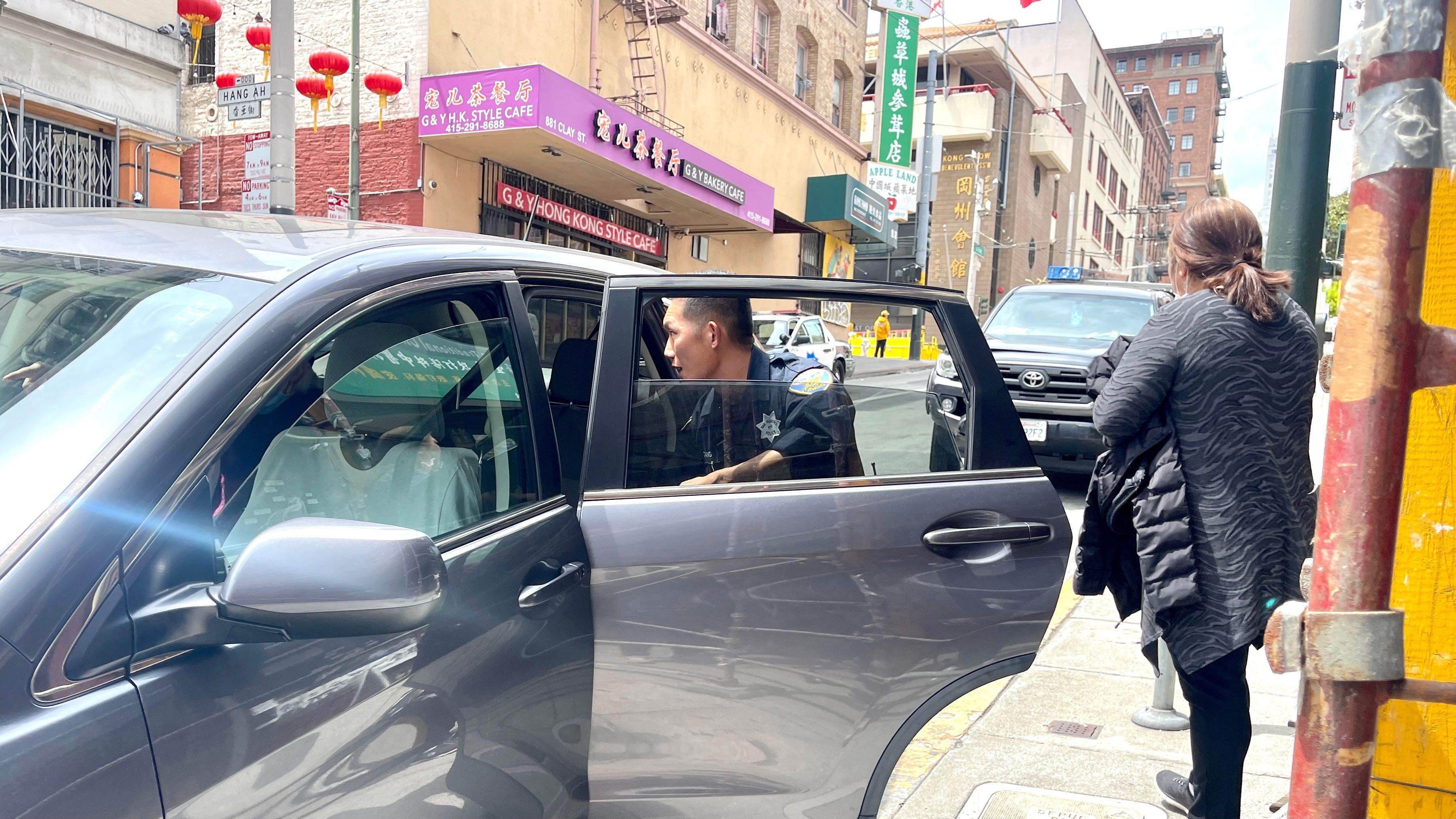 Ms. Yu (right) is one of the latest victims in the smash-and-grab robberies targeting Asian women motorists. She is robbed of her purse by two suspects on Clay Street in SF Chinatown on May 3.  Photo by Portia Li
