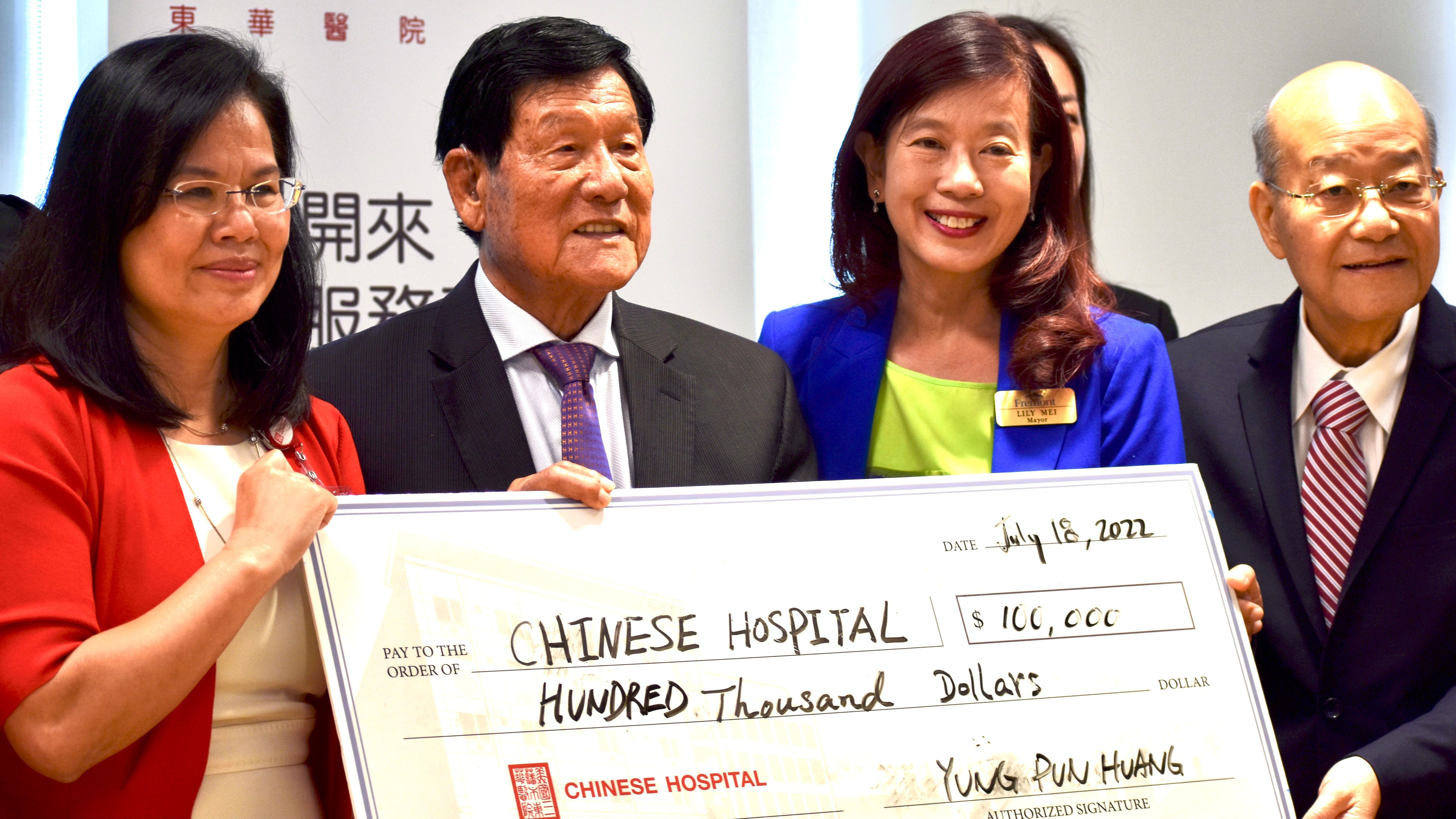 Yung Pun Huang (second from far left) gives his second $100,000 donation to the Chinese Hospital on his 90 years old birthday. Photo by Portia Li