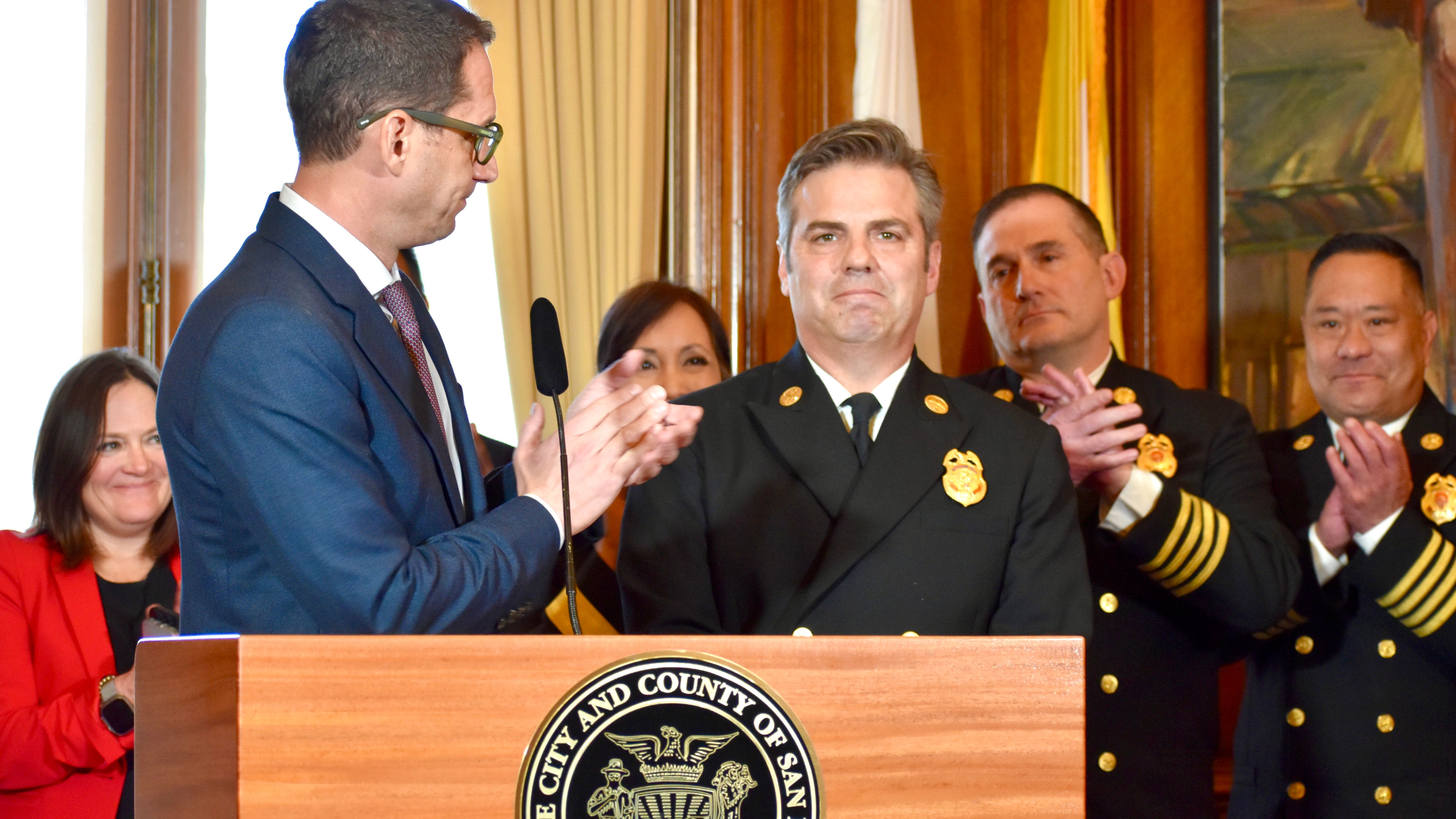 On the third day after Daniel Lurie (left in front row) was sworn into office as San Francisco Mayor, he appoints 34-year veteran firefighter Dean Crispen (right in front row) as Fire Chief. Photo by Portia Li