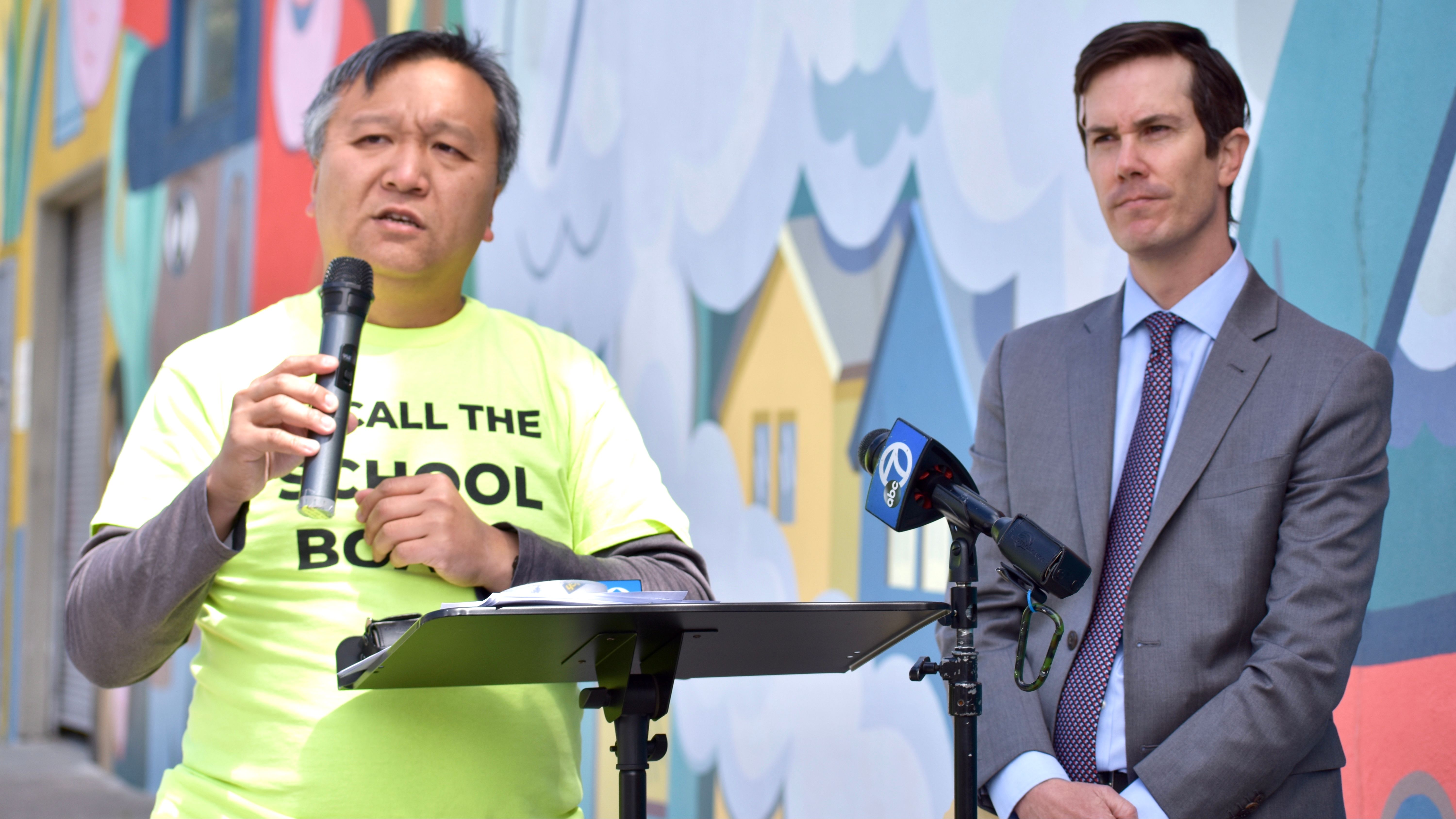 Parent volunteer Man Kit Lam (left) and his lawyer John Roach announce the civil lawsuit against Jason Kruta for stealing the signatures gathered in the recall school board petitions. Photo by Portia Li