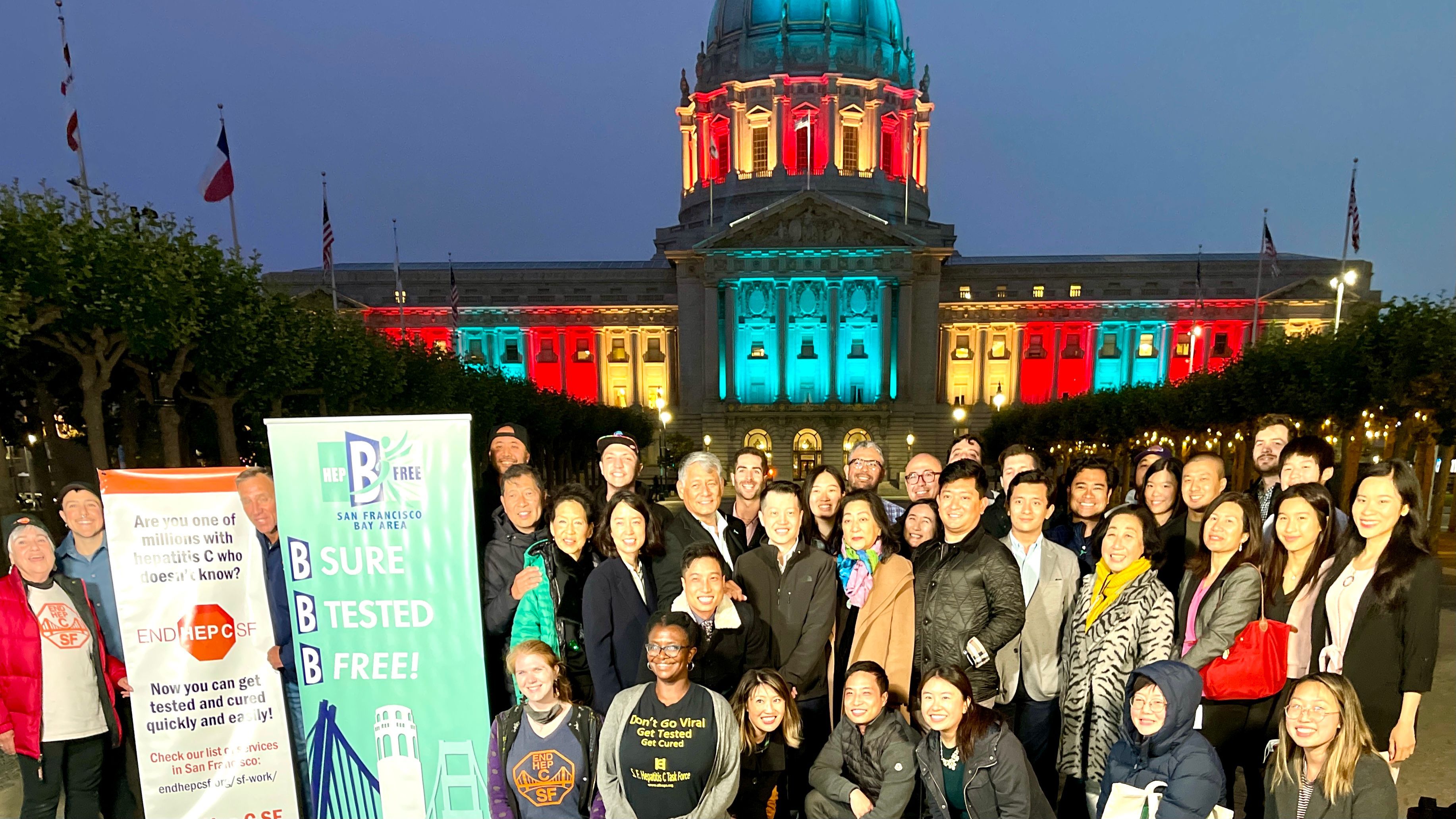 San Francisco City Hall lights up on July 28 in honor of World Hepatitis Day. SF Hep B Free Bay Area supporters gather to celebrate. Photo by Portia Li