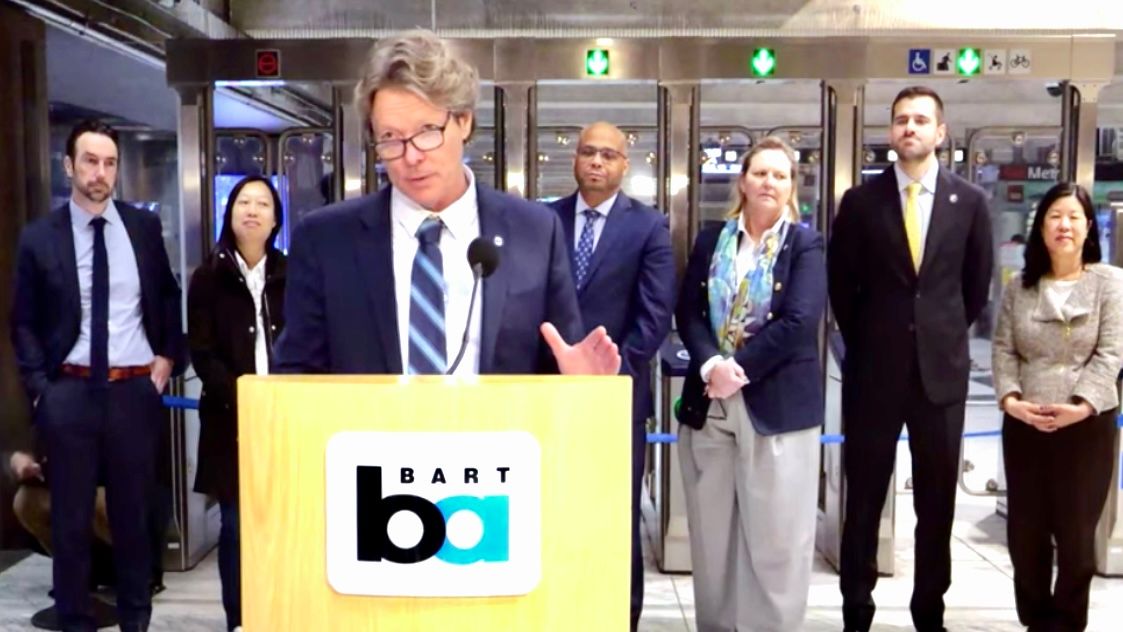 BART General Manager Bob Powers (center) announces the completion of installing new fare gates at all four San Francisco downtown stations. Screenshot 