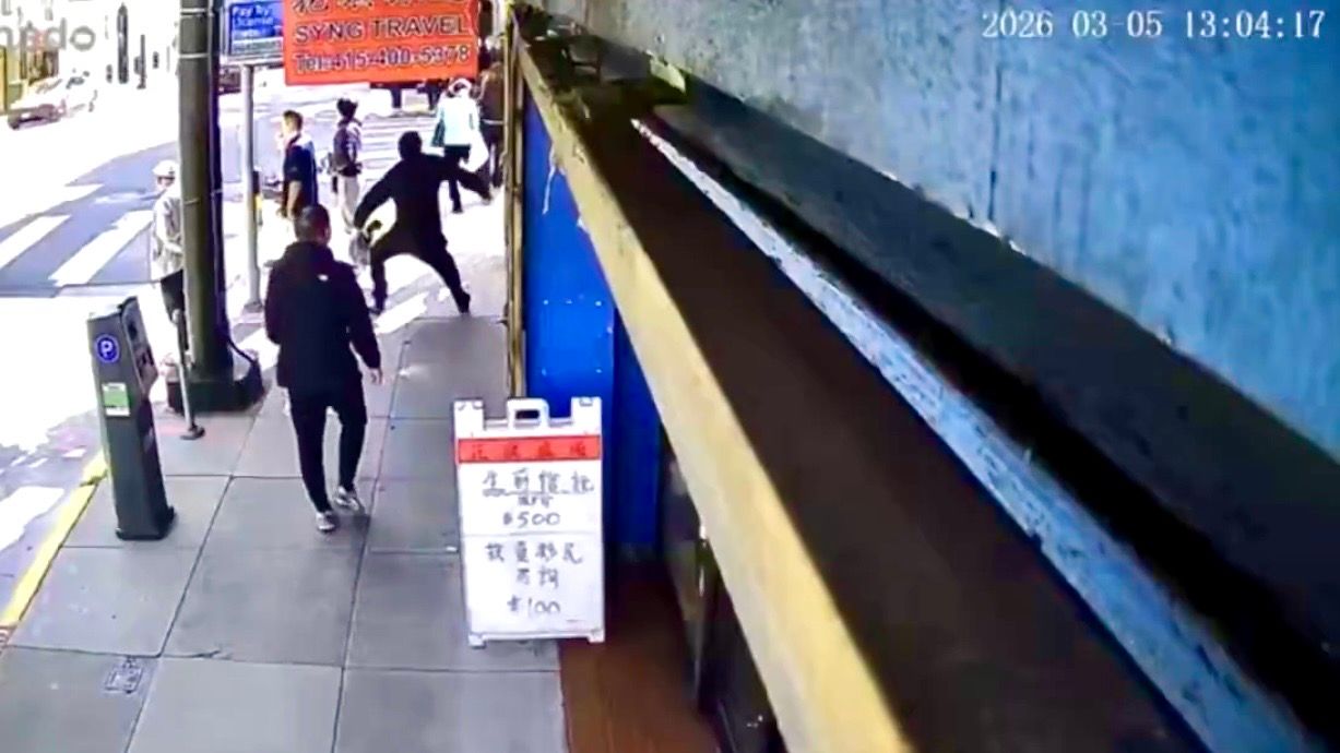 A random stabbing that occurred during lunch hours on March 5 on the busy Stockton Street corridor has shocked the community. Surveillance footage shows the 38-year-old suspect, wearing black clothing and a hoodie, pull out a knife and stab the 22-year-old victim in the back, critically injuring him. Screenshot photo