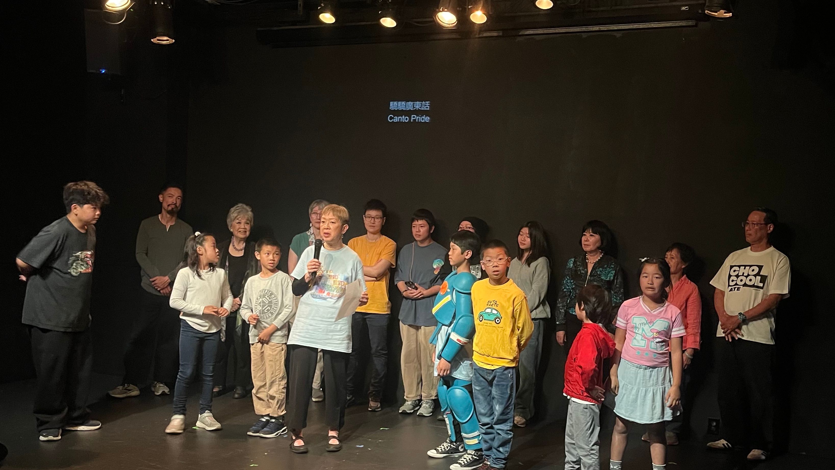 The cast and crew of “Canto Pride” perform during a rehearsal for the show at the Clarion Performing Arts Center. Clara Hsu (speaking), founder of the center and playwright of Canto Pride, makes remarks in the show about her mission to preserve and promote Cantonese culture. Photo by Joseph Woo Chan