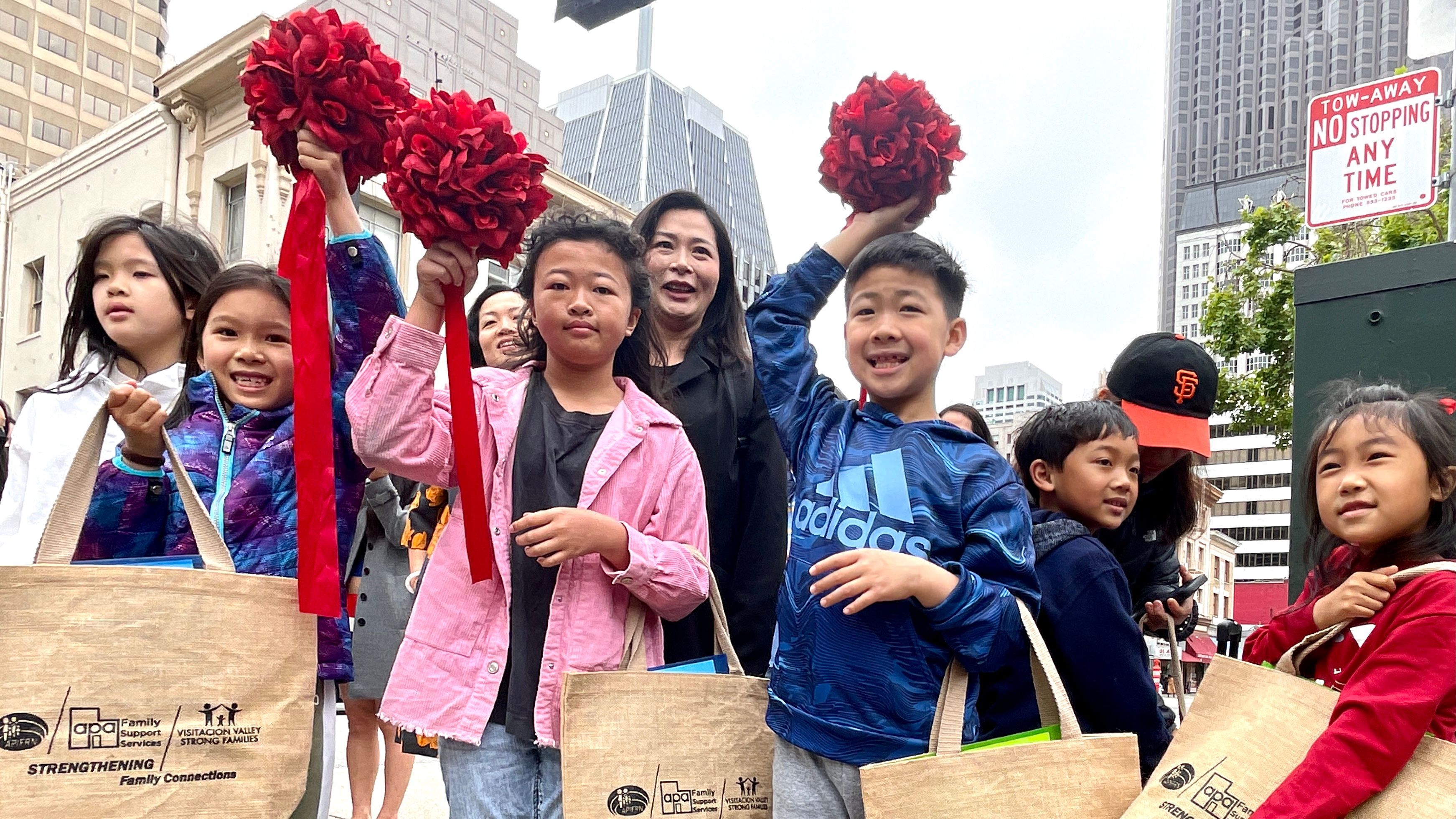 The young artists and winners join the exhibit opening ceremony at the Portsmouth Square Garage, including Nikki Wu (left), Champion Award winner Natalie Yuan (center), and Winson Chan. Photo by Portia Li